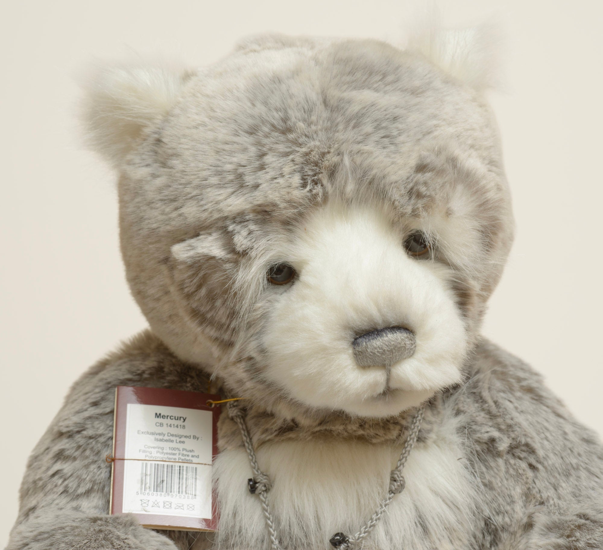 Charlie Bears Mercury - Isabelle Collection - close up face and swing tag showing product code CB141418, bear name Mercury, exclusively designed by Isabelle Lee