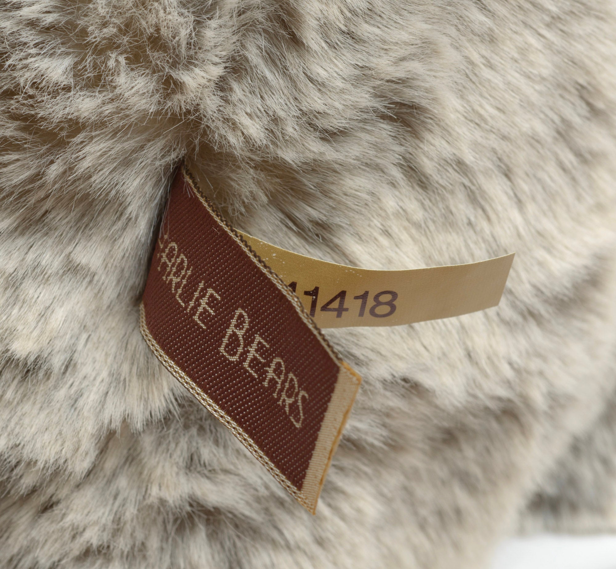 Charlie Bears Mercury - Isabelle Collection - label detail showing Charlie Bears woven label in cream on dark brown with CB141418 cream fabric strip alongside