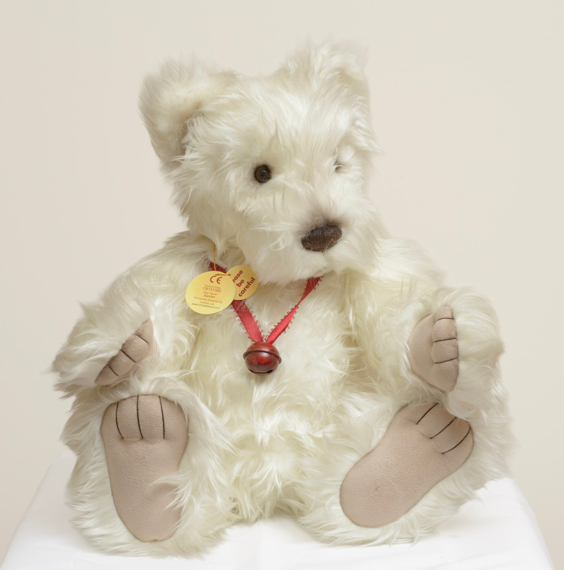 Charlie Bears Baxter - Isabelle Collection - close up face showing long wild white plush, wide set dark brown glass eyes, large sculpted dark brown nose and swing tag