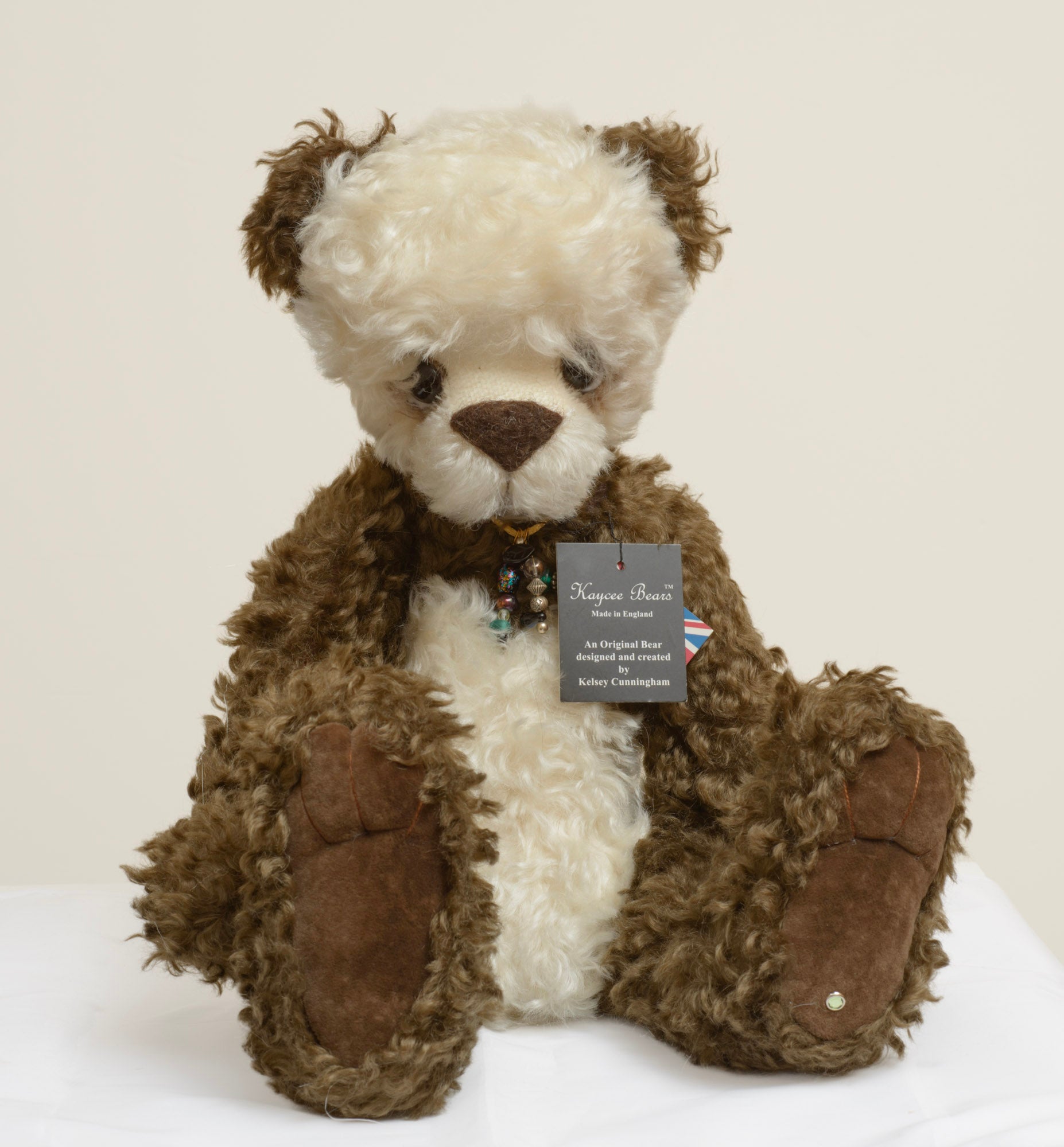 Kaycee Bears Simkin - Kelsey Cunningham - Kaycee Bears swing tag reading Made in England, An Original Bear designed and created by Kelsey Cunningham, with bead necklace visible