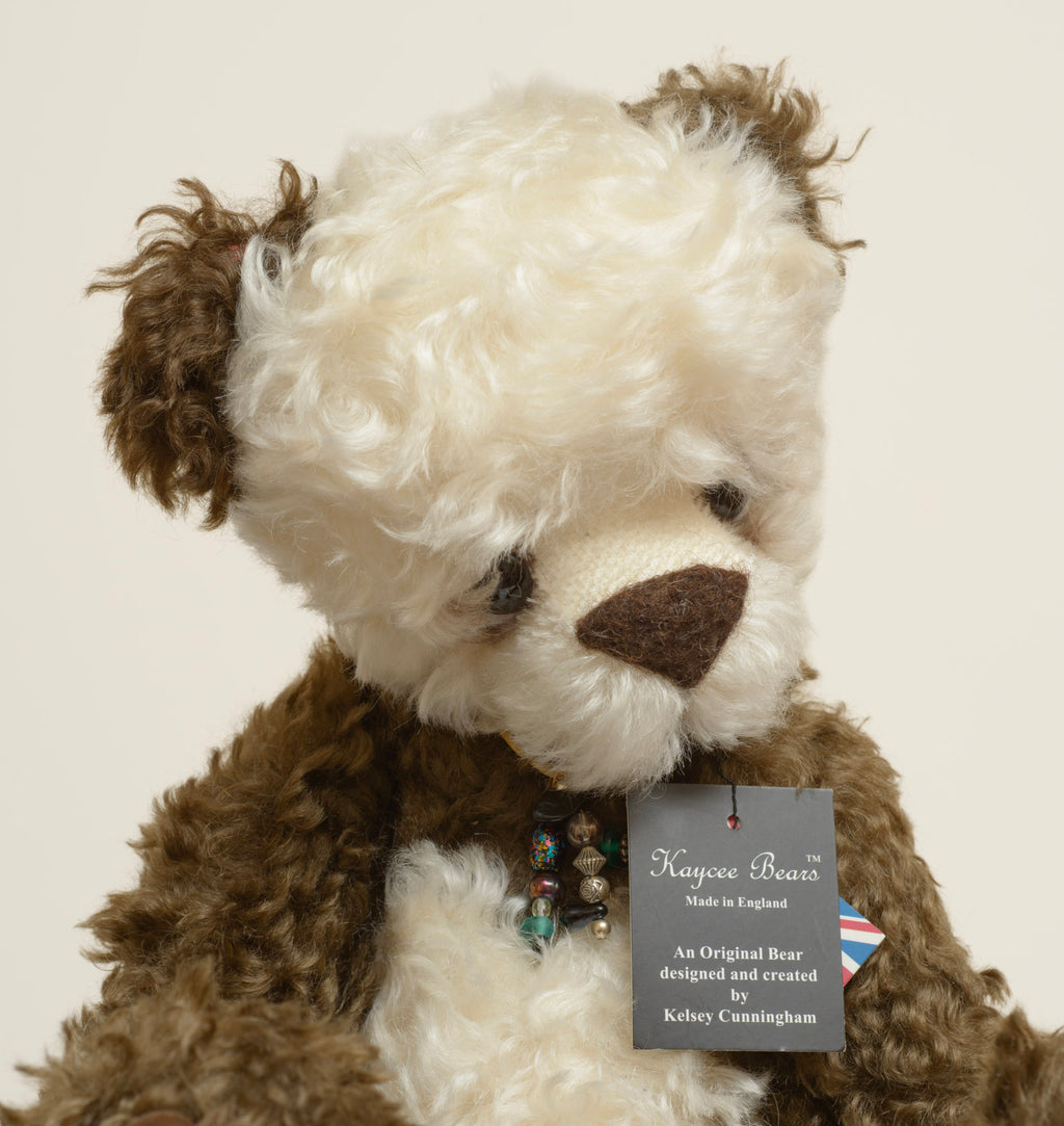 Kaycee Bears Simkin - Kelsey Cunningham - paw pad detail showing large dark brown suede effect pad with jointing disc visible, in dark chocolate curly plush
