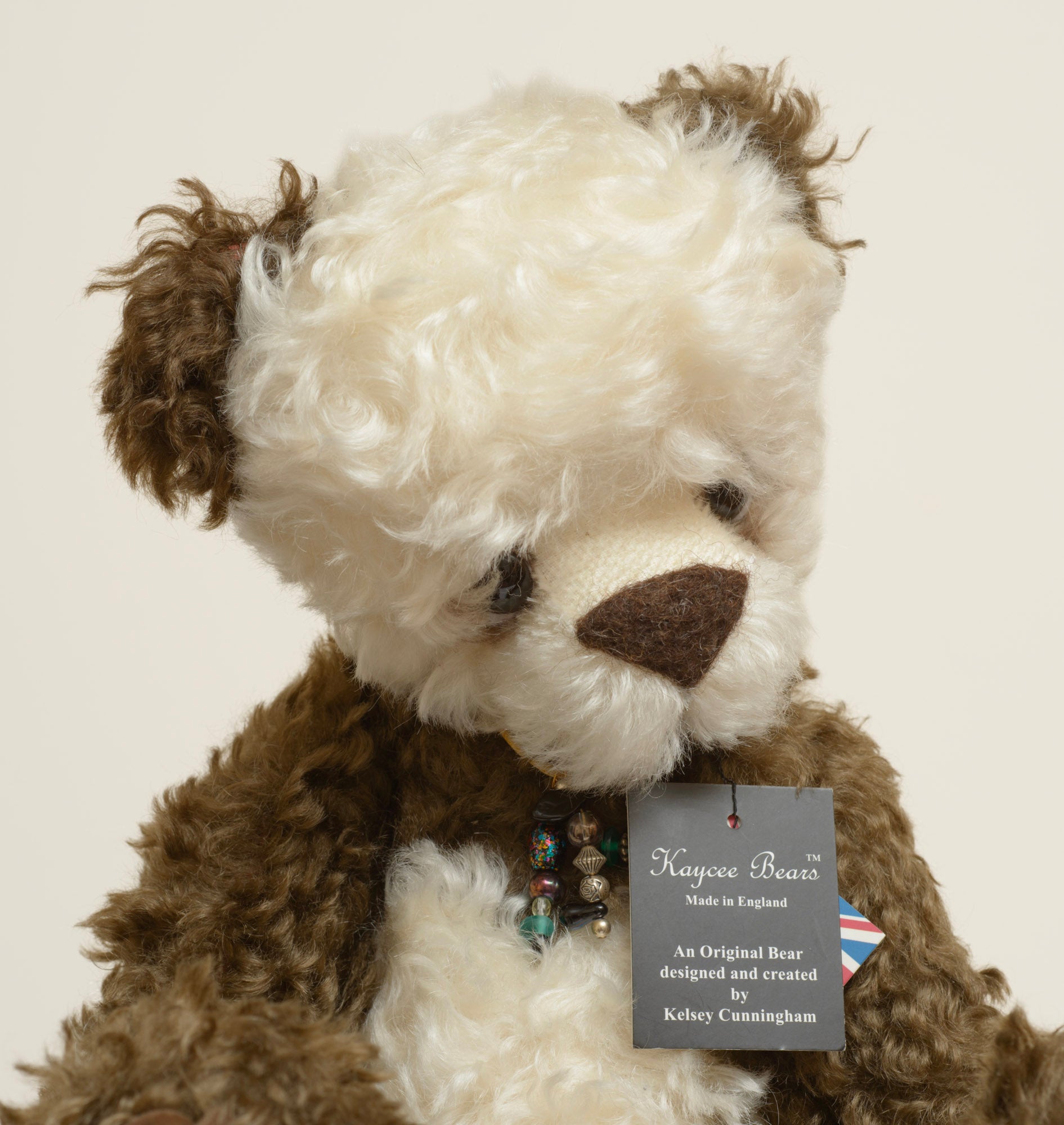 Kaycee Bears Simkin - Kelsey Cunningham - paw pad detail showing large dark brown suede effect pad with jointing disc visible, in dark chocolate curly plush