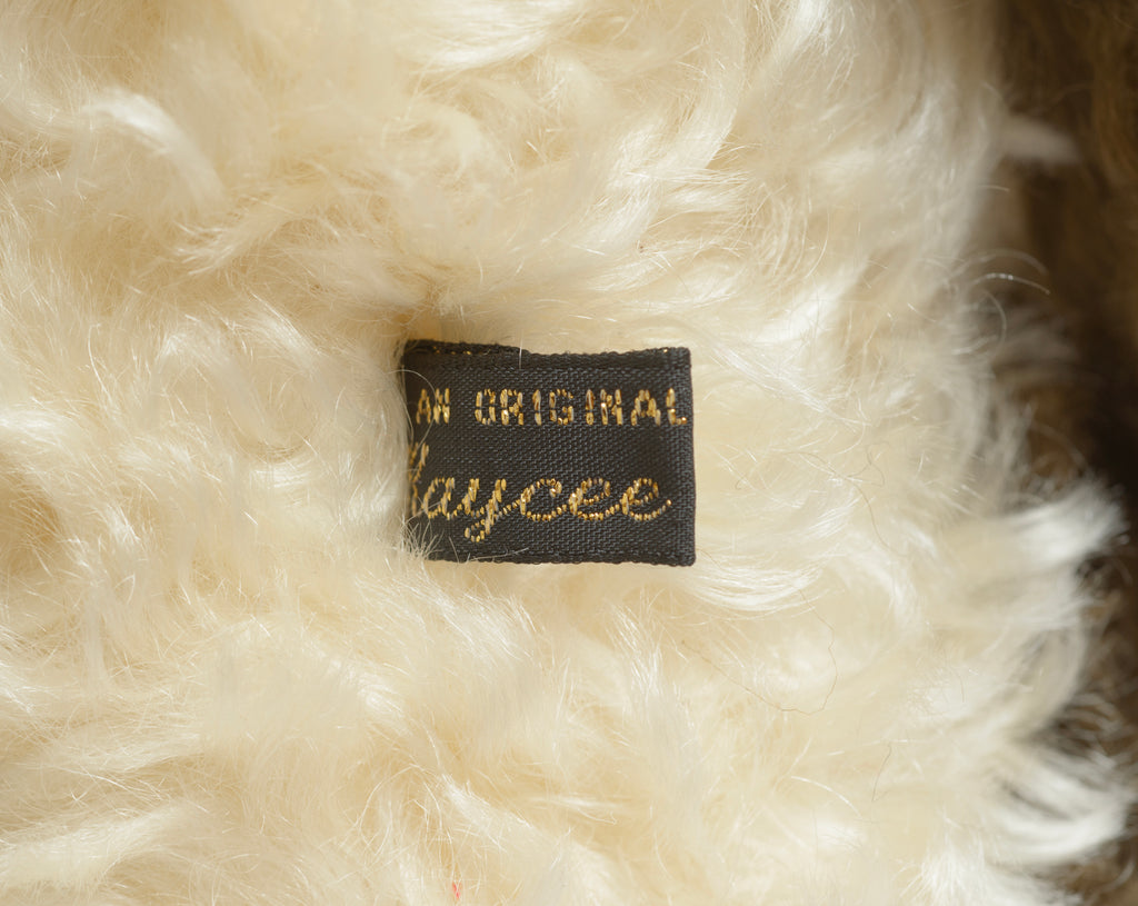 Kaycee Bears Simkin - Kelsey Cunningham - full front seated view showing two-tone dark chocolate and cream curly plush with old gold bead necklace
