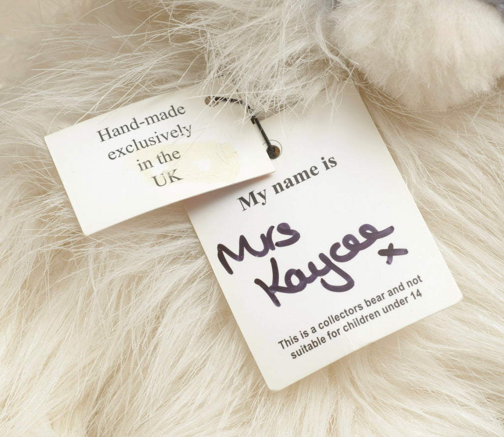 Kaycee Bears Mrs Kaycee - Kelsey Cunningham - rear view showing long cream ivory plush coat with pink satin bow and AN ORIGINAL Kaycee woven label set on the diagonal