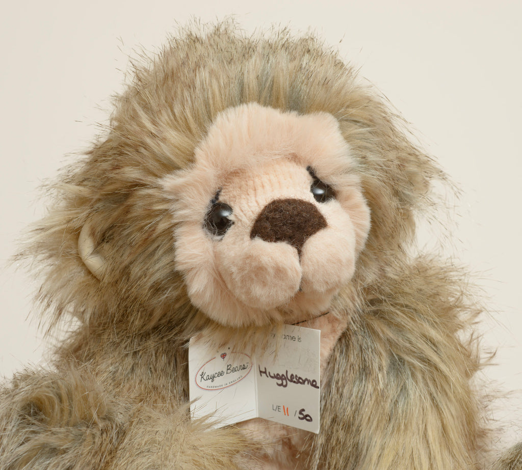Kaycee Bears Hugglesome - Kelsey Cunningham - paw pad detail showing large plain blush pink suede effect pad with jointing disc visible against long sandy taupe plush