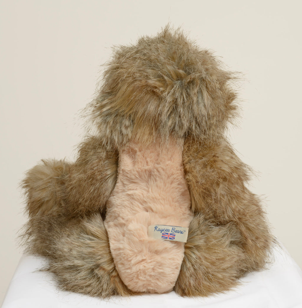 Kaycee Bears Hugglesome - Kelsey Cunningham - three-quarter view showing contrast between long wild sandy taupe outer coat and shorter blush pink curly plush tummy panel and inner ears