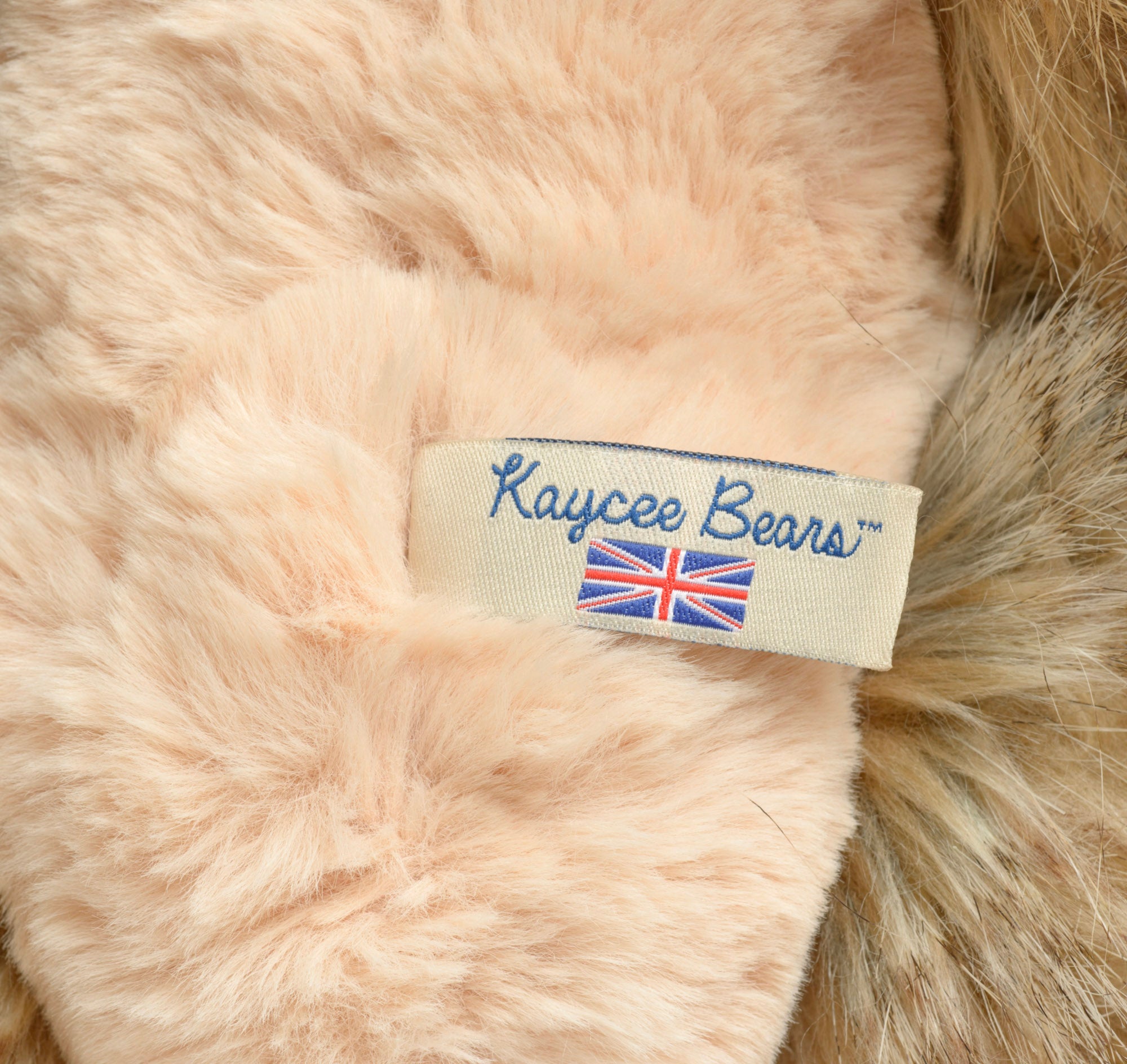 Kaycee Bears Hugglesome - Kelsey Cunningham - side profile showing full long wild sandy taupe plush coat with darker tipped hairs and blush pink muzzle