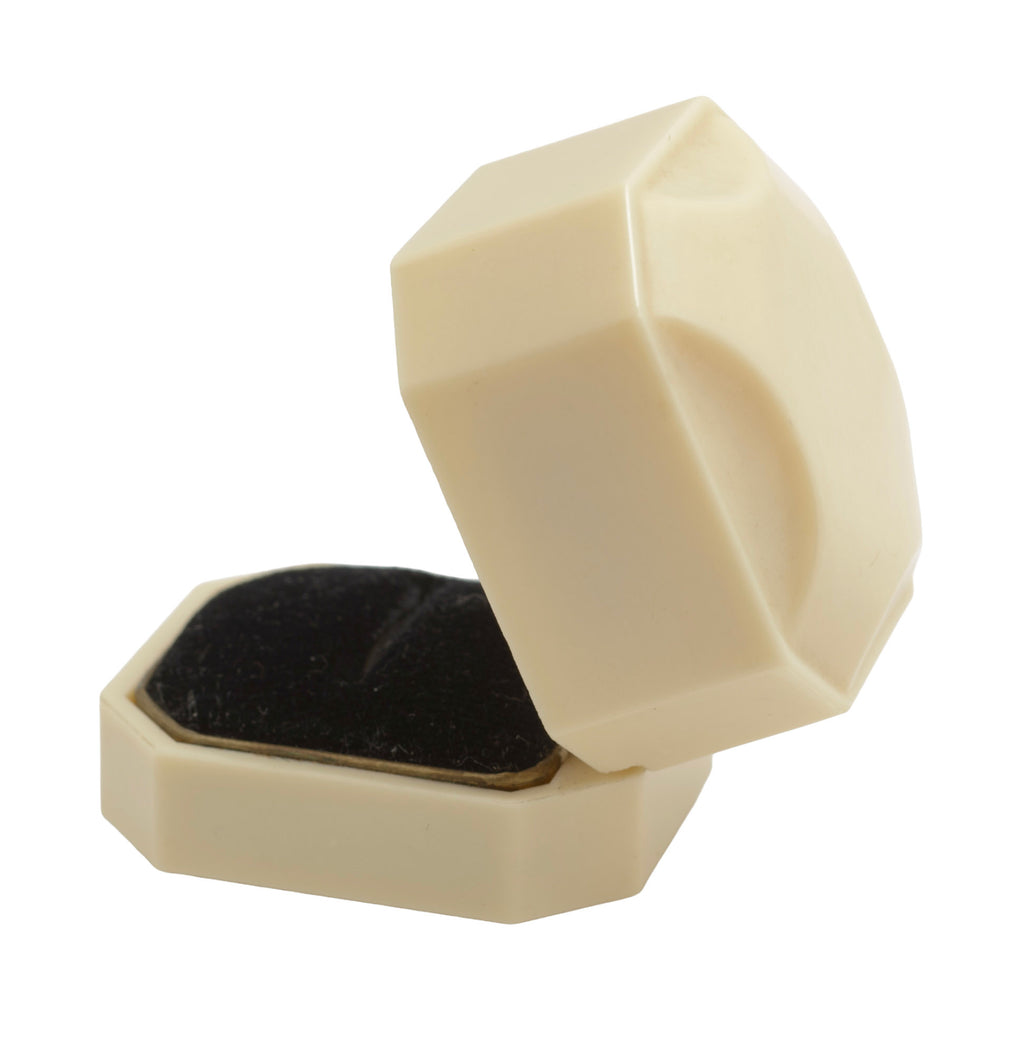 Art Deco ALCA Bakelite ring box - cream - side view closed showing stepped lid profile and octagonal faceted body on grey background