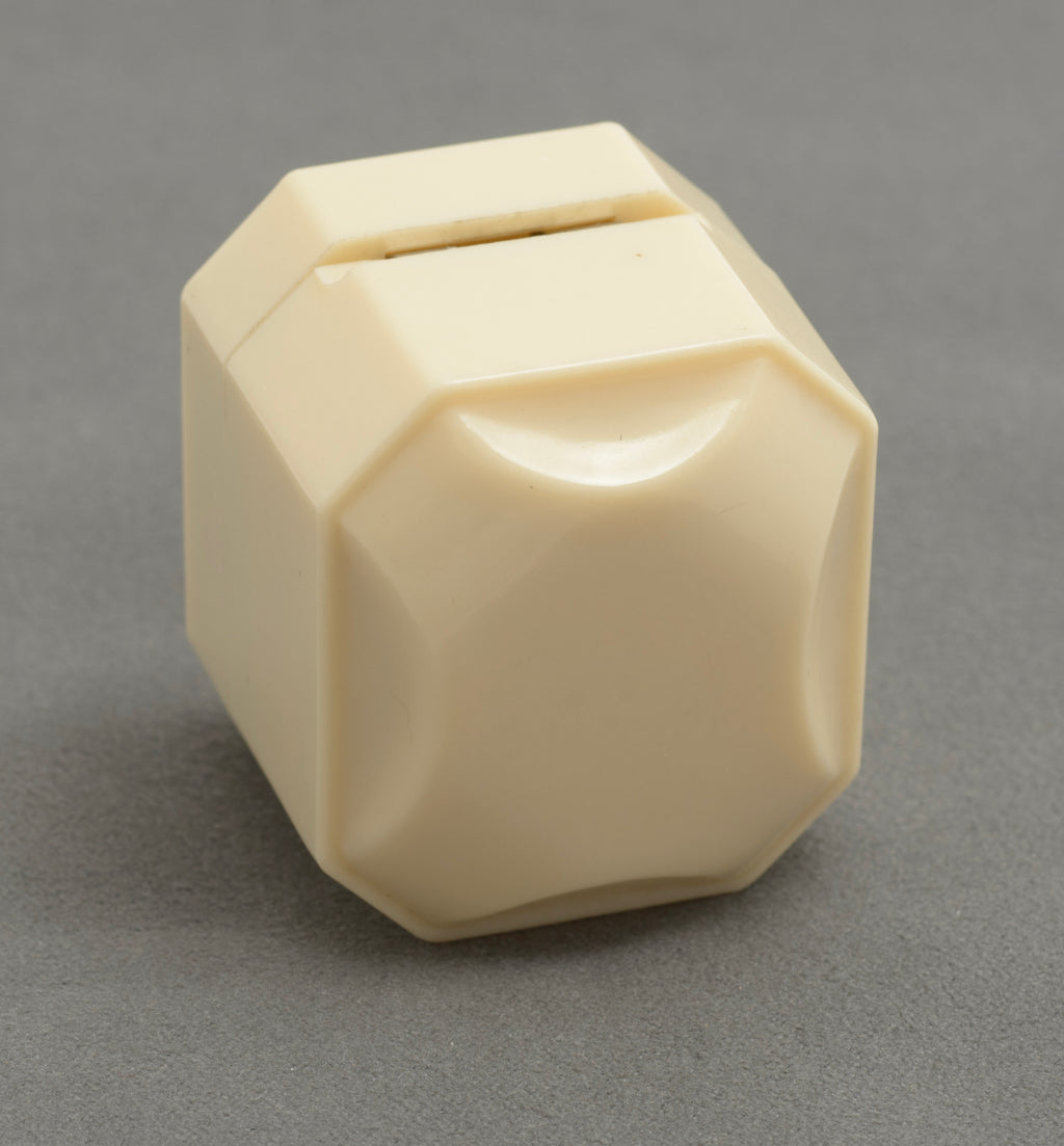 Art Deco ALCA Bakelite ring box - cream - full view closed showing complete octagonal faceted form on grey background
