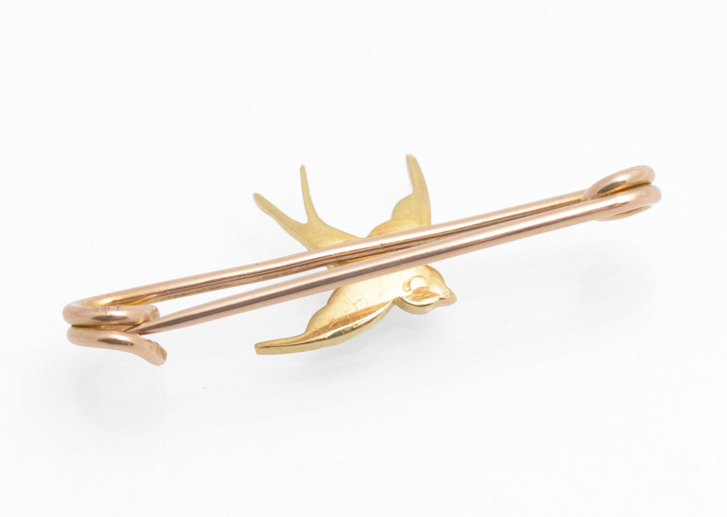 Victorian 15ct gold swallow brooch - natural turquoise and split pearls - three-quarter front view showing bright blue turquoise cabochons and split pearls against warm 15ct yellow gold swallow body