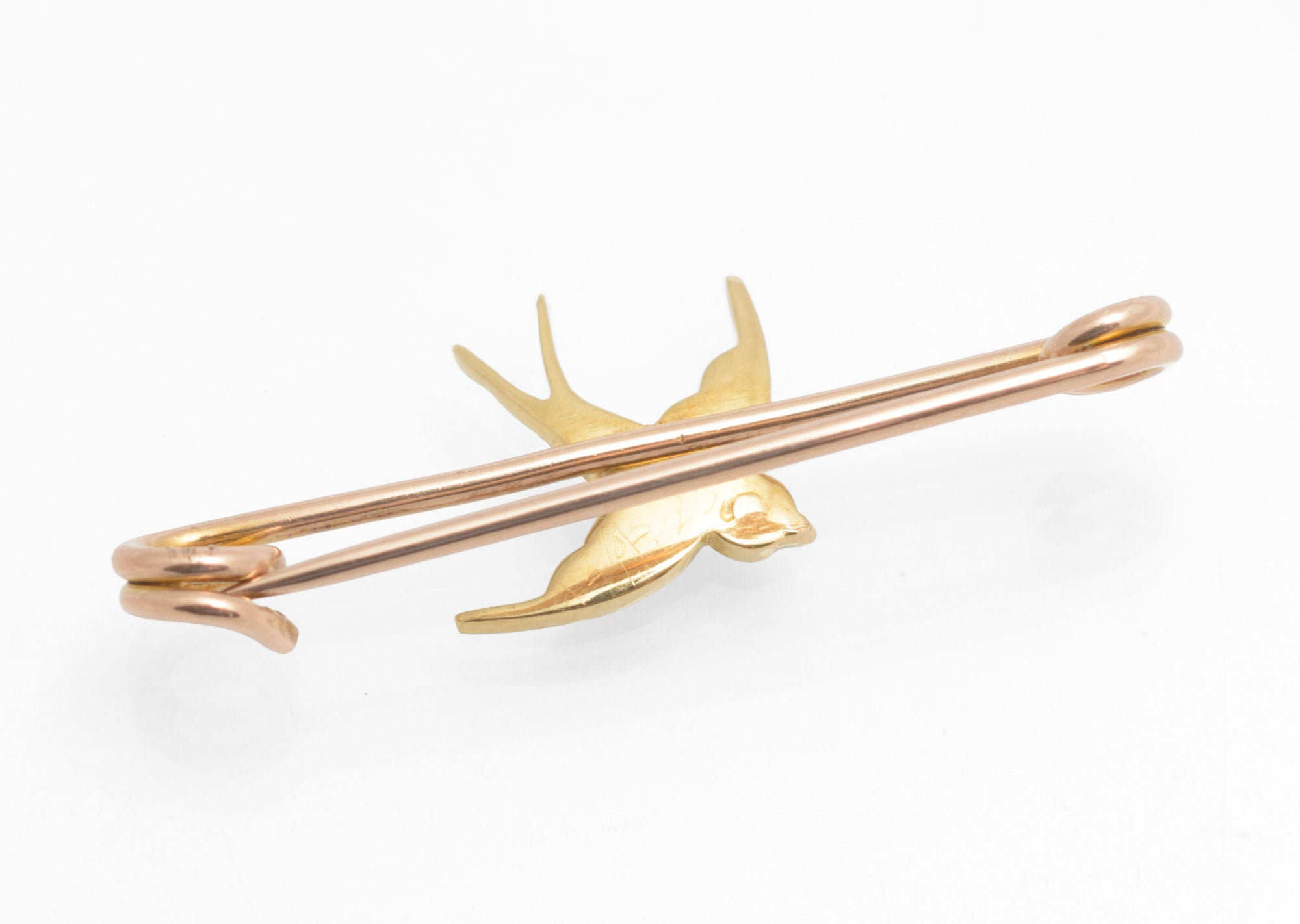 Victorian 15ct gold swallow brooch - natural turquoise and split pearls - three-quarter front view showing bright blue turquoise cabochons and split pearls against warm 15ct yellow gold swallow body