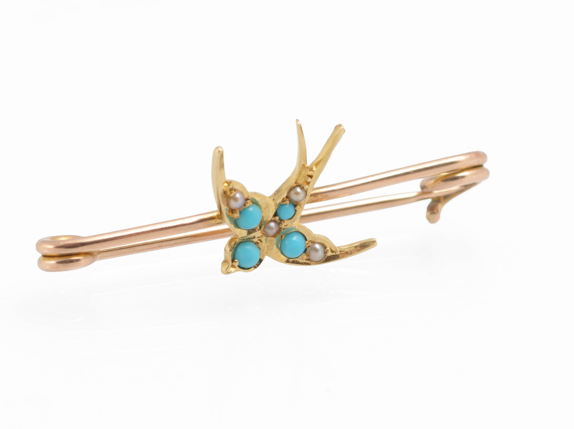 Victorian 15ct gold swallow brooch - natural turquoise and split pearls - angled view showing contrast between 15ct yellow gold swallow and 9ct rose gold pin fitting with scroll ends