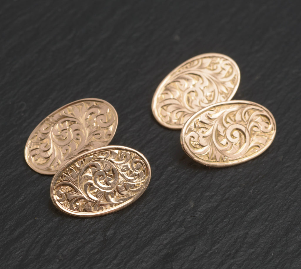 Antique 9ct light rose gold cufflinks - engraved foliate scrolls - front view showing all four oval panels with dense hand engraved acanthus scroll and leaf decoration on dark slate background