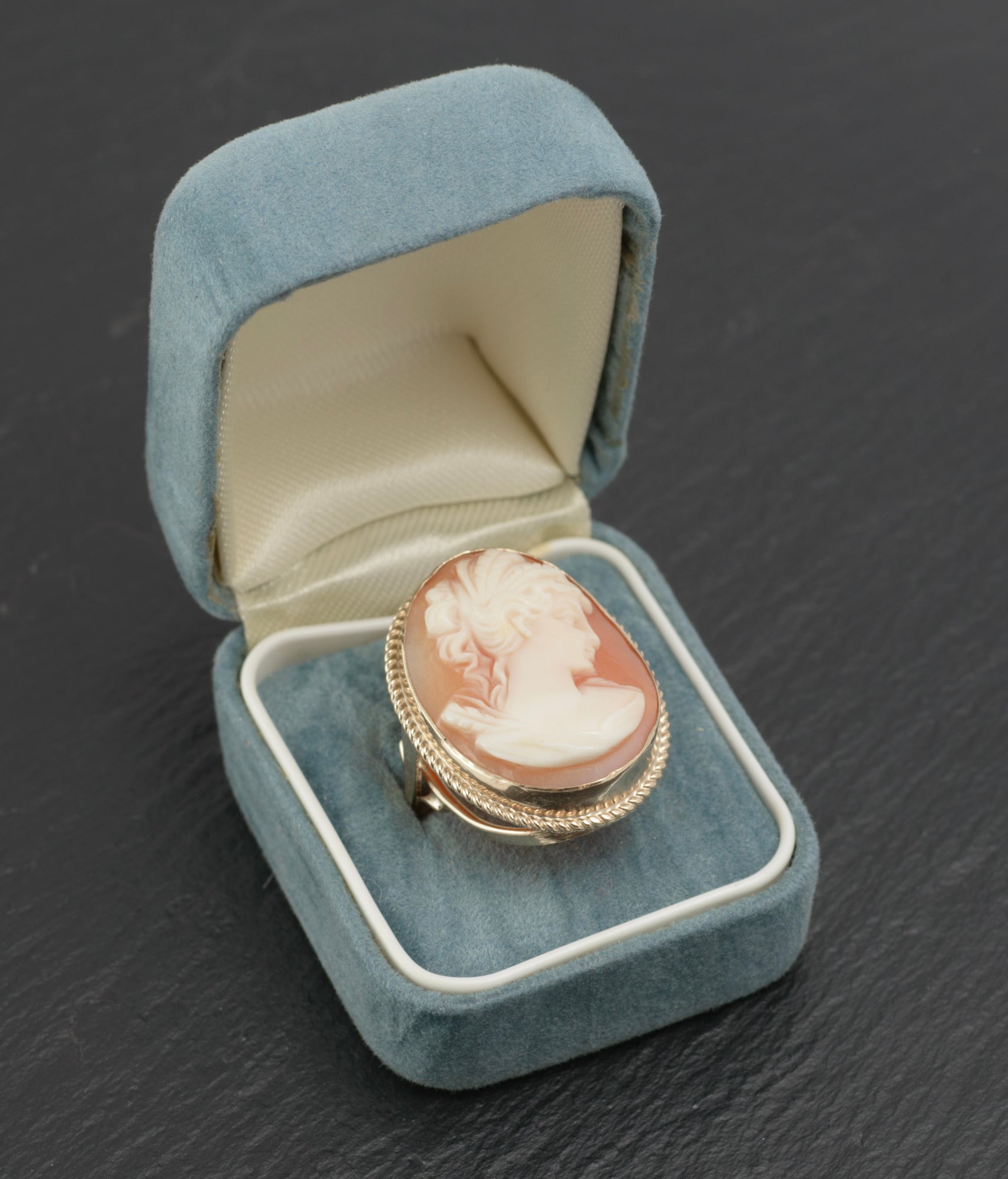 Vintage 9ct gold cameo ring - large carved shell portrait cameo - rear three-quarter view on dark slate showing open gallery of sweeping crossed supports and rope twist bezel border