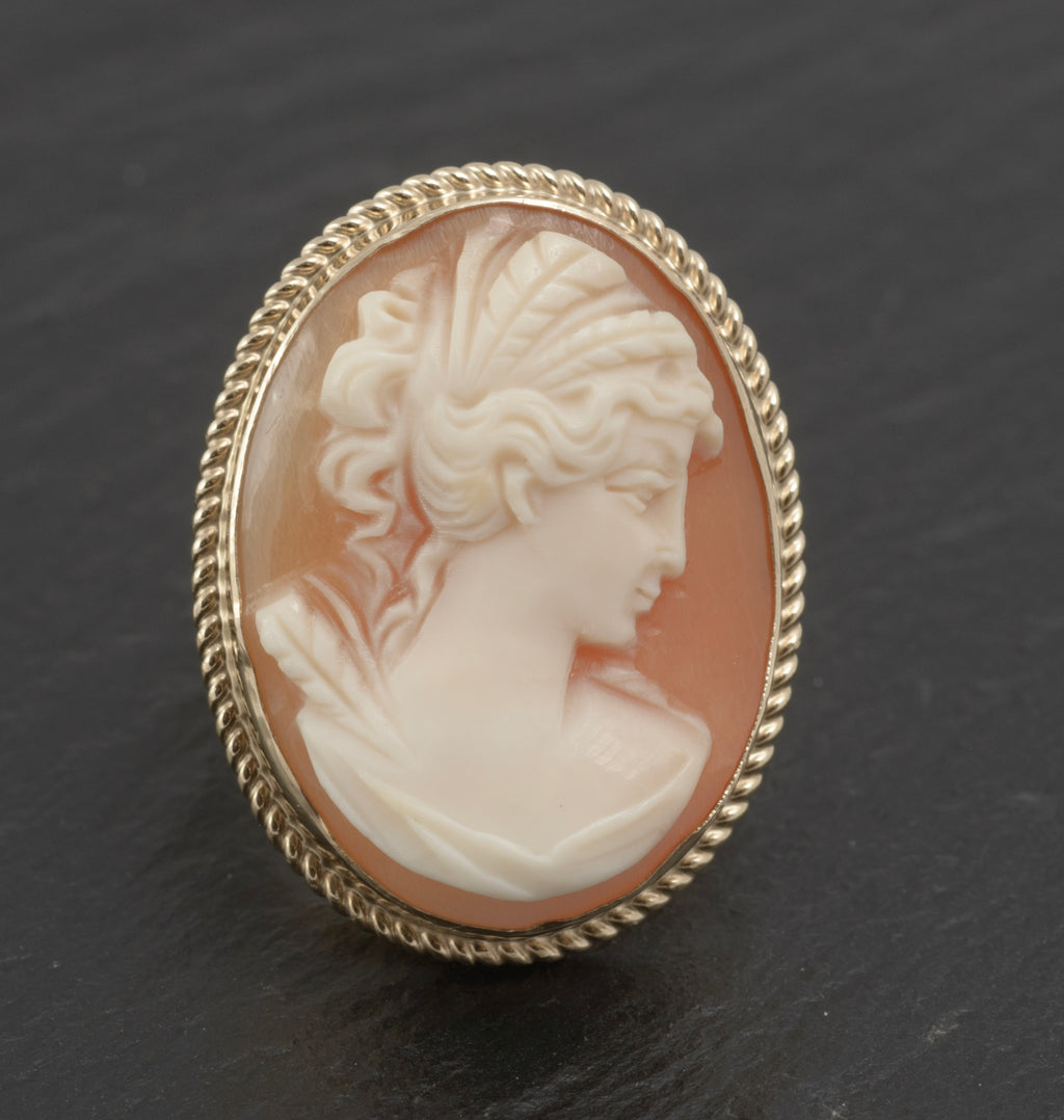 Vintage 9ct gold cameo ring - large carved shell portrait cameo - full front view on white background showing classical female profile in high relief with pale cream portrait against warm peach shell ground in rope twist bezel