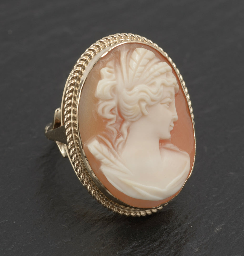 Vintage 9ct gold cameo ring - large carved shell portrait cameo - three-quarter front view on white background showing cameo head with hair detail, facial profile and drapery in open gallery gold mount