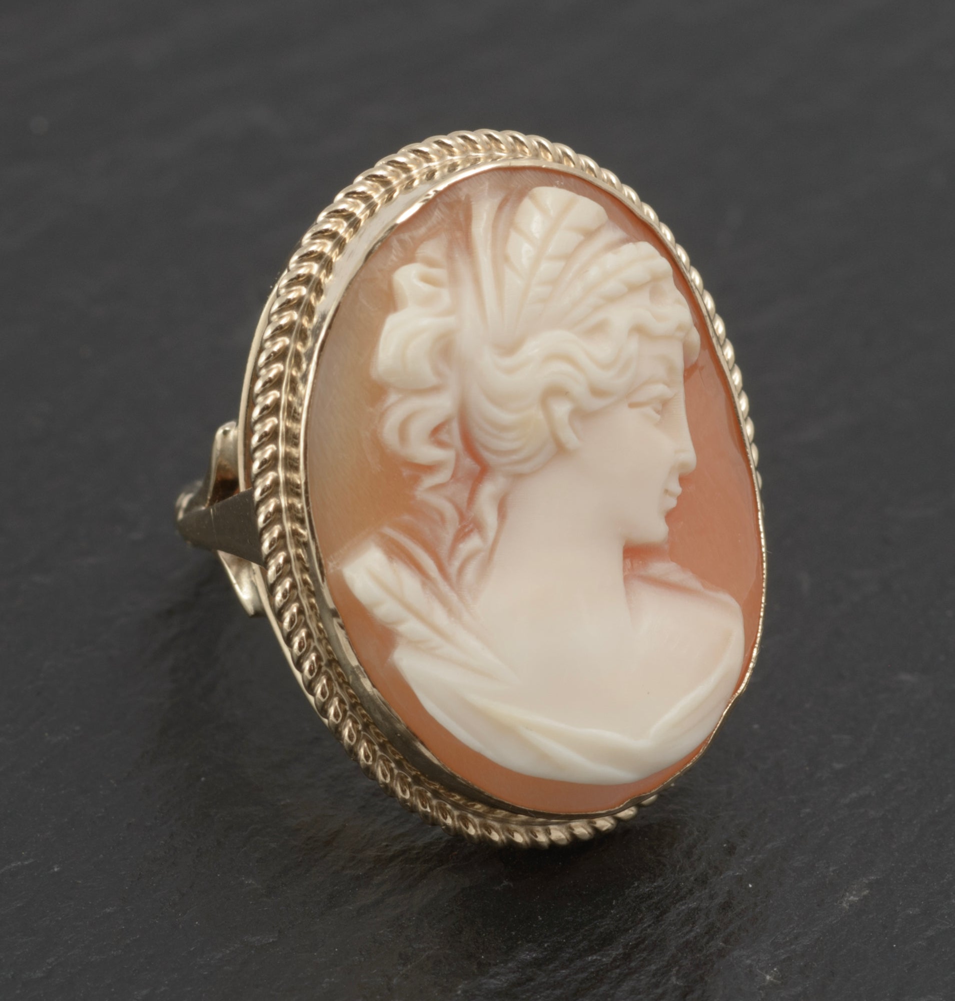 Vintage 9ct gold cameo ring - large carved shell portrait cameo - three-quarter front view on white background showing cameo head with hair detail, facial profile and drapery in open gallery gold mount