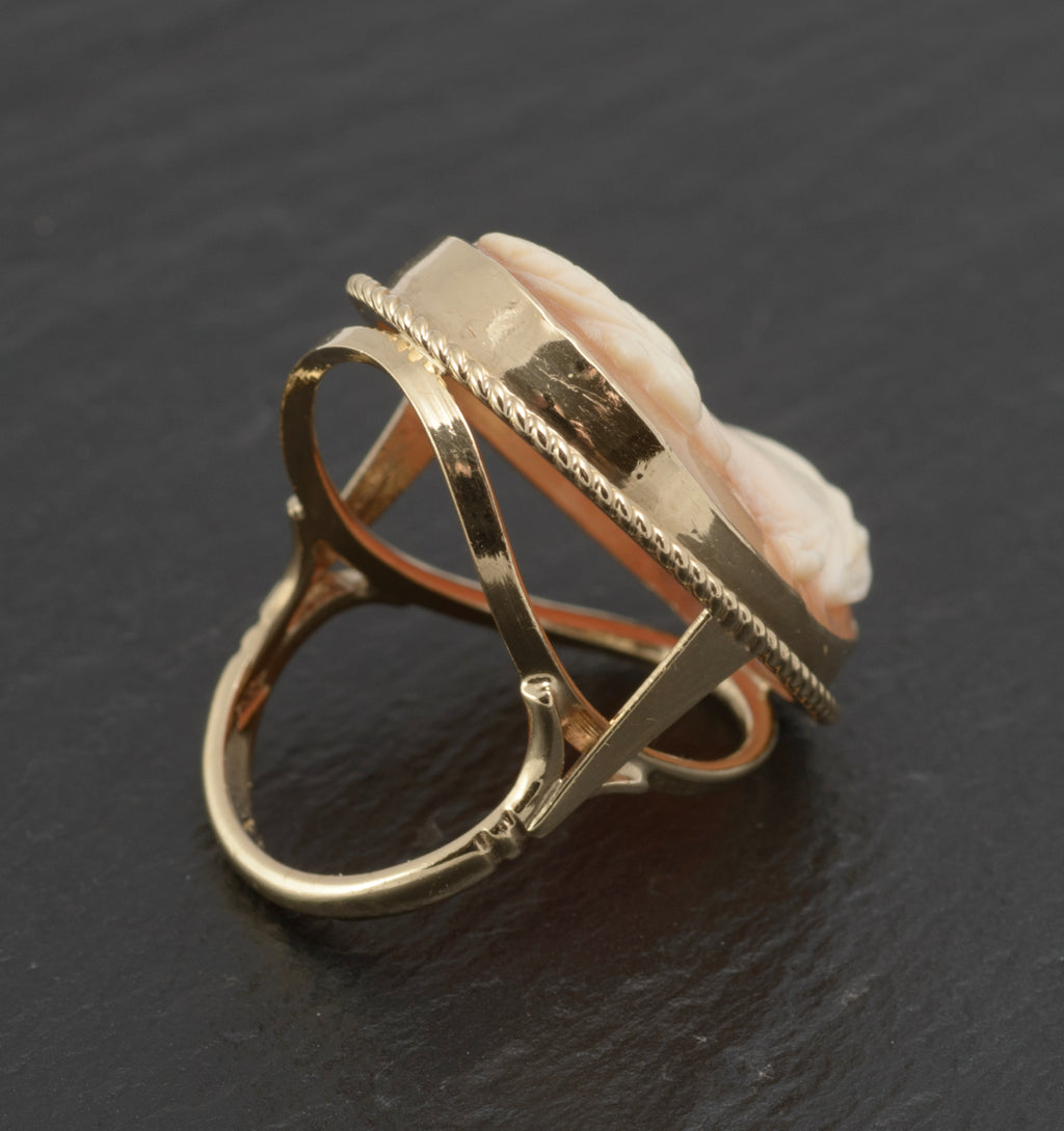 Vintage 9ct gold cameo ring - large carved shell portrait cameo - rear three-quarter view on white background showing open gallery of sweeping crossed gold supports beneath rope twist bezel
