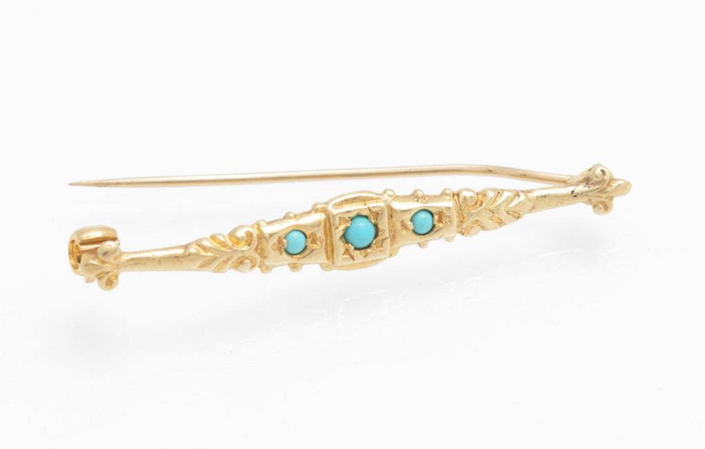 Vintage 9ct gold bar brooch - natural turquoise - Edwardian revival - three-quarter view with pin open showing rollover safety catch at right end and three turquoise cabochons across decorated gold bar on white background