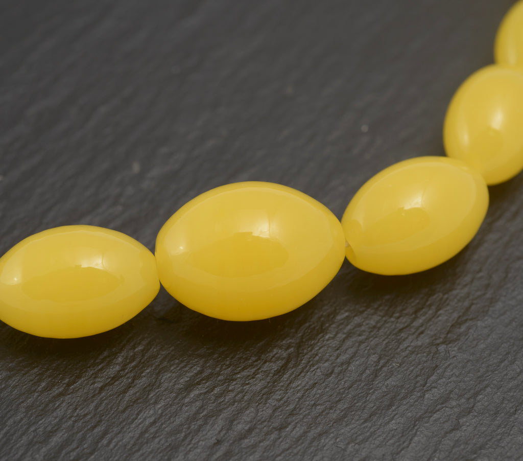 Art Deco uranium vaseline glass bead necklace - vivid opaque yellow - close up of central graduating beads showing smooth polished oval forms and consistent warm yellow colour
