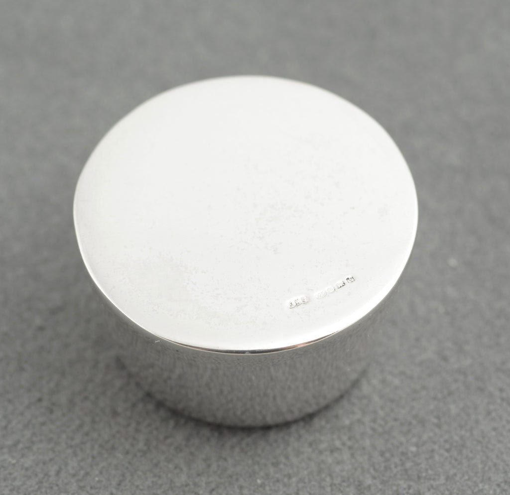 Sterling silver My Last Rolo keepsake - Sheffield 2005 - C. W. Sellors - angled view showing tapered cylindrical form with recessed circular base and high polish finish on grey background