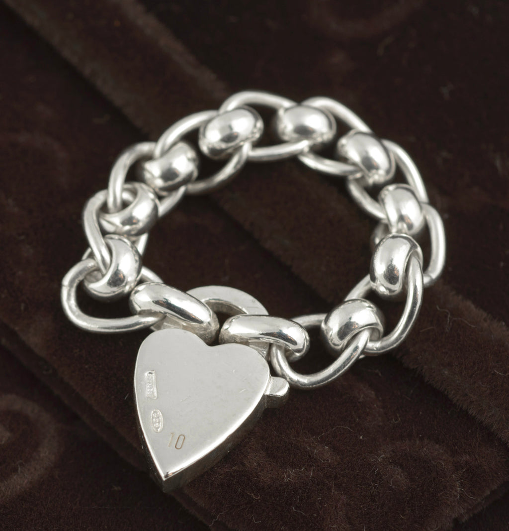 Gucci sterling silver chain link ring with heart charm - reverse view of heart charm showing Italian silver hallmarks and 925 sterling silver mark to lower left on dark background