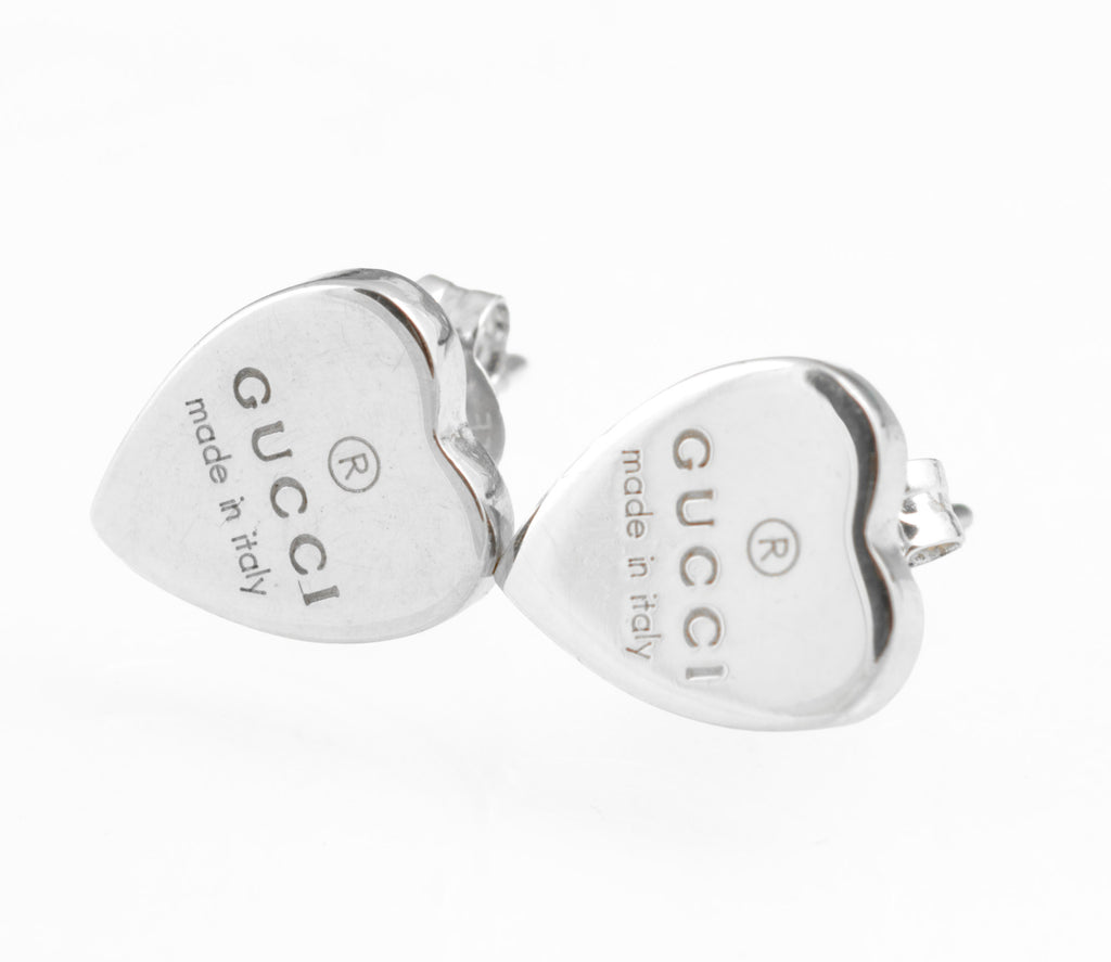 Gucci sterling silver heart stud earrings - made in Italy - pair shown front face on white background showing both hearts with Gucci name and made in italy engraving and registered trademark symbol clearly visible