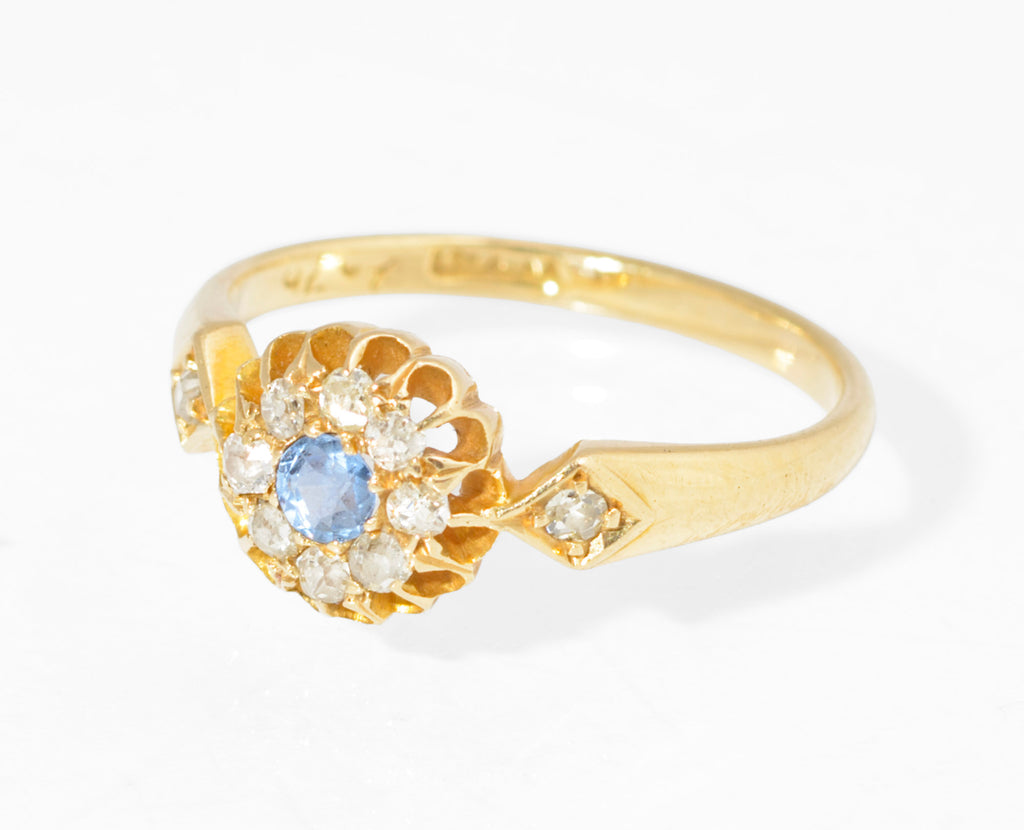 Antique 18ct gold sapphire and diamond cluster ring - three quarter view showing lozenge diamond shoulders