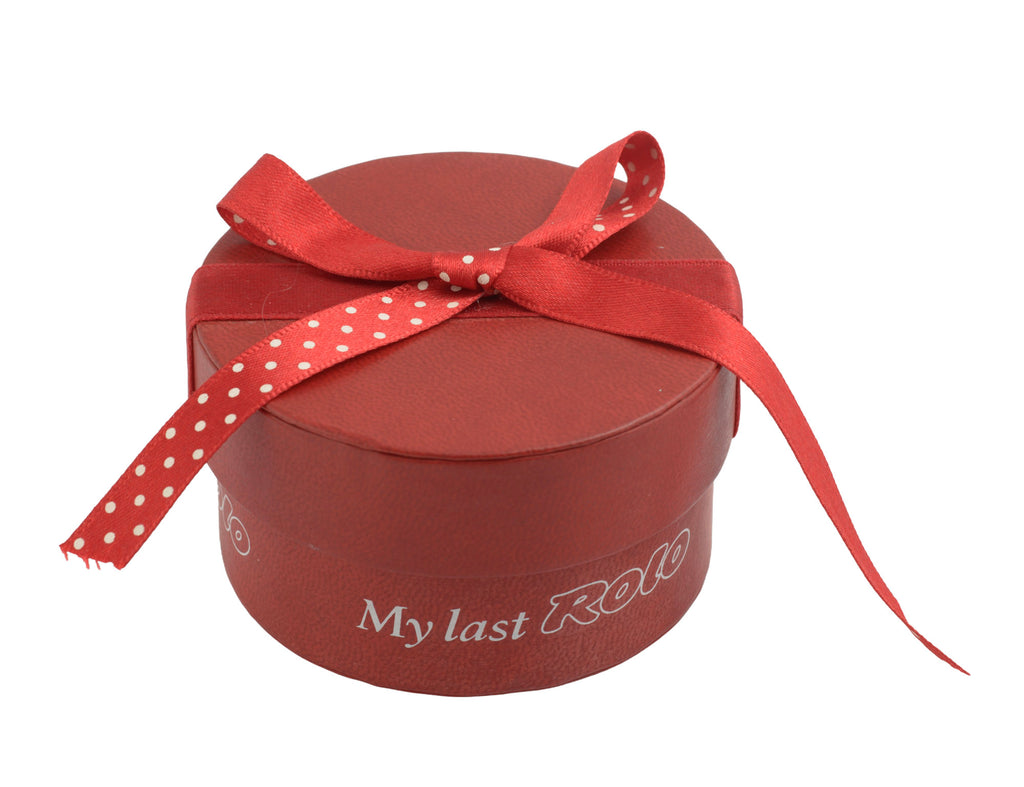 Sterling silver My Last Rolo keepsake - Sheffield 2003 - C. W. Sellors - closed red cylindrical My Last Rolo presentation box with polka dot ribbon bow tied on top on white background