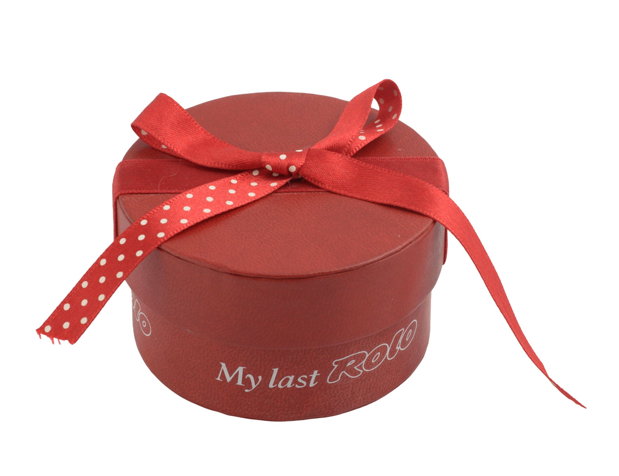 Sterling silver My Last Rolo keepsake - Sheffield 2003 - C. W. Sellors - closed red cylindrical My Last Rolo presentation box with polka dot ribbon bow tied on top on white background