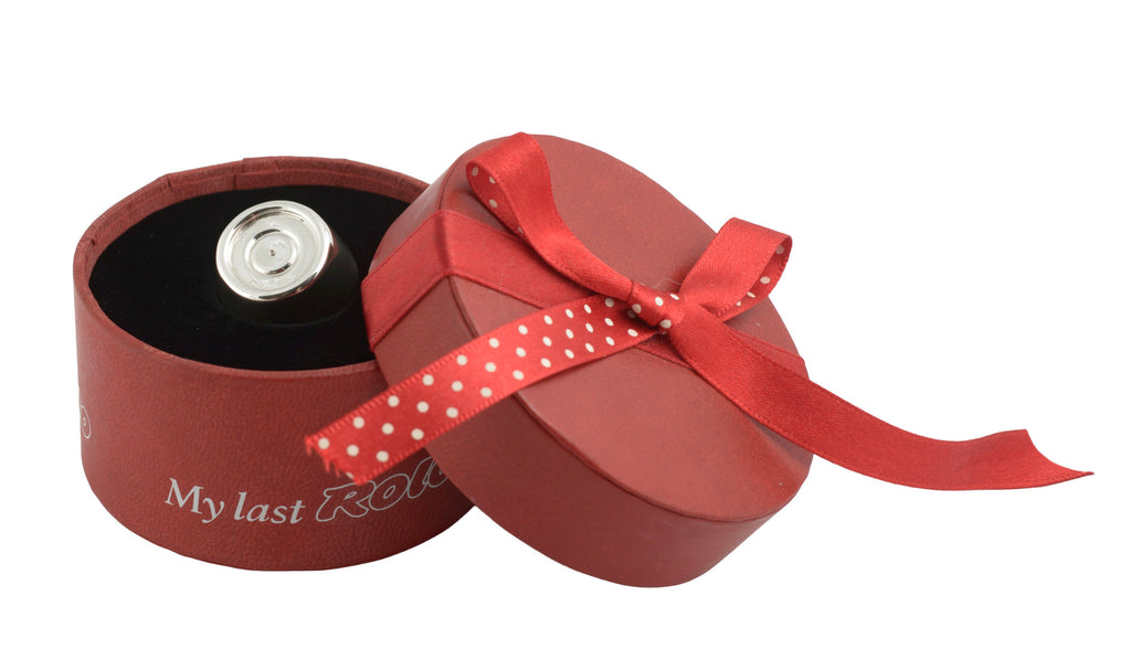 Sterling silver My Last Rolo keepsake - Sheffield 2003 - C. W. Sellors - open red cylindrical My Last Rolo presentation box with lid and polka dot ribbon to side showing solid silver Rolo sitting in black velvet interior on white background