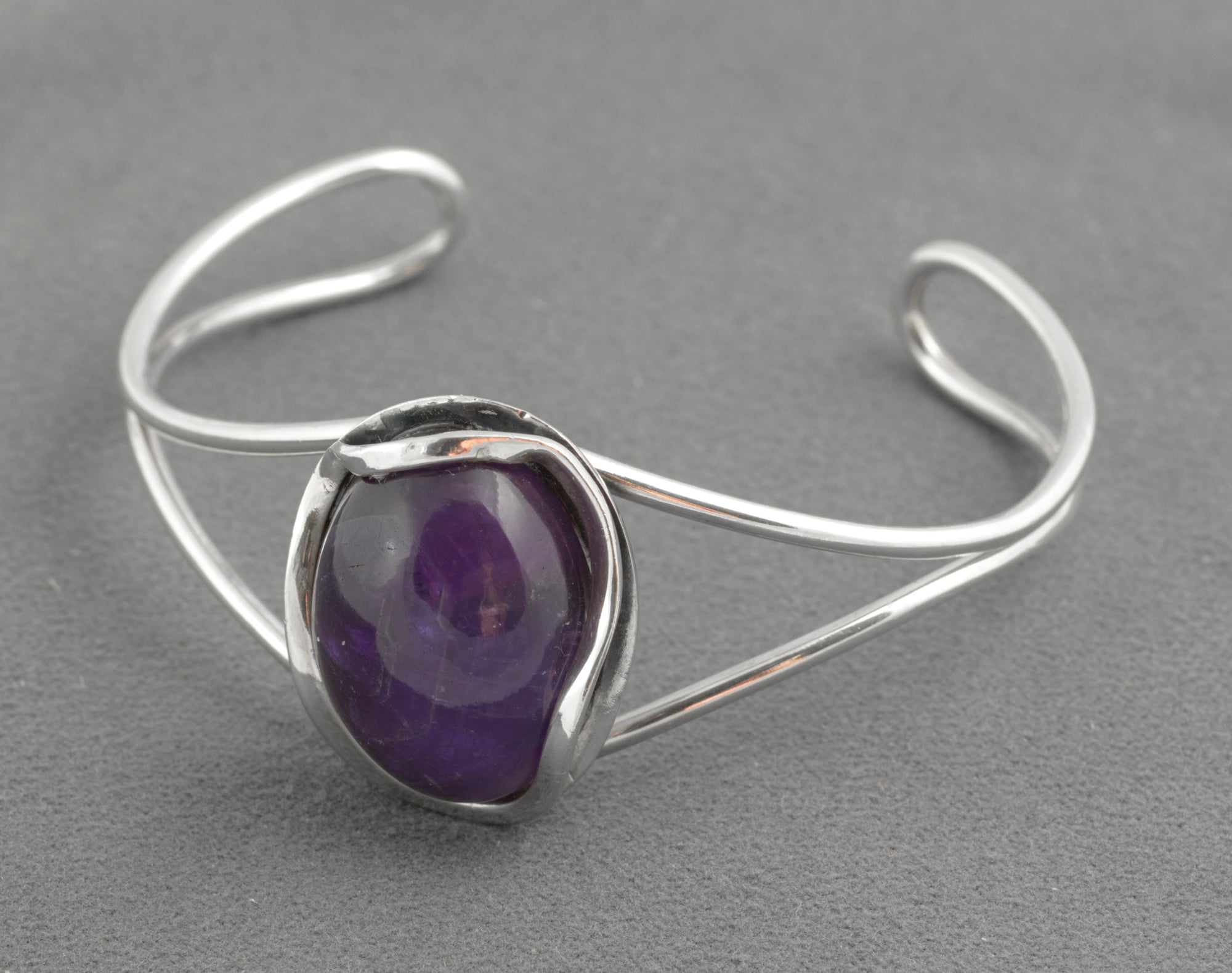 Vintage sterling silver amethyst cabochon bangle - Polish handmade - Gdańsk 925 - front view on white background showing large high domed natural amethyst cabochon with deep violet centre and colour zoning in parallel wire form open cuff setting
