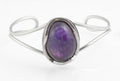 Vintage sterling silver amethyst cabochon bangle - Polish handmade - Gdańsk 925 - rear three-quarter view on white background showing Gdańsk 925 hallmark and additional marks to inner edge of bangle arm with open back amethyst setting
