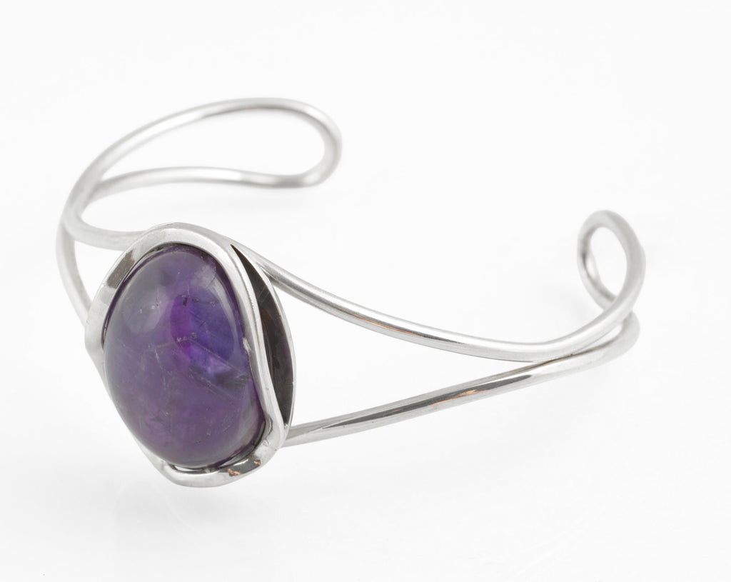 Vintage sterling silver amethyst cabochon bangle - Polish handmade - Gdańsk 925 - angled rear view on white background showing scrolled wire terminals open cuff form and reverse of amethyst setting with hallmarks visible