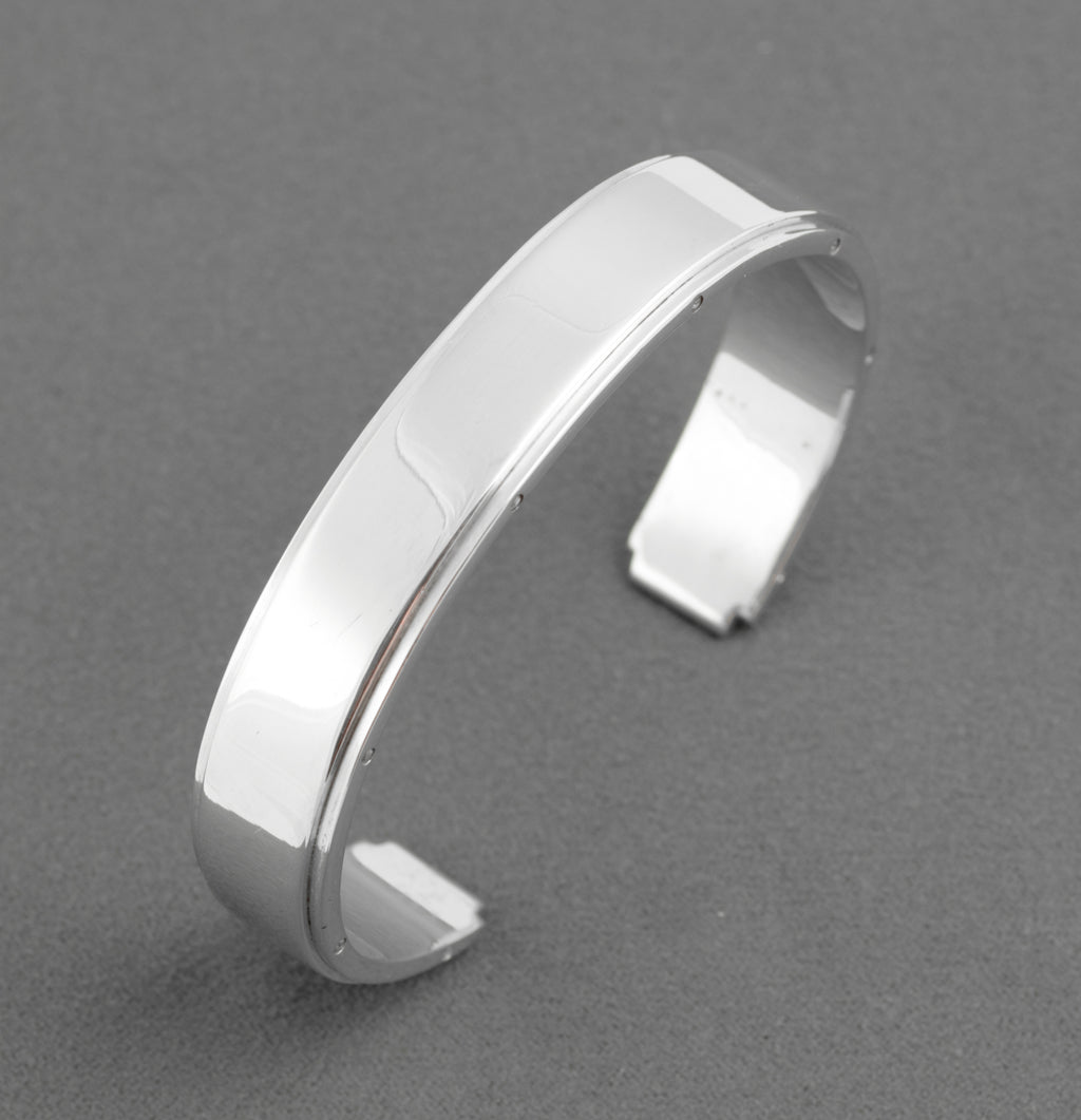 Tiffany and Co Metropolis sterling silver cuff bangle - 925 - bangle resting on original Tiffany blue presentation box on white background showing Tiffany and Co name on box lid