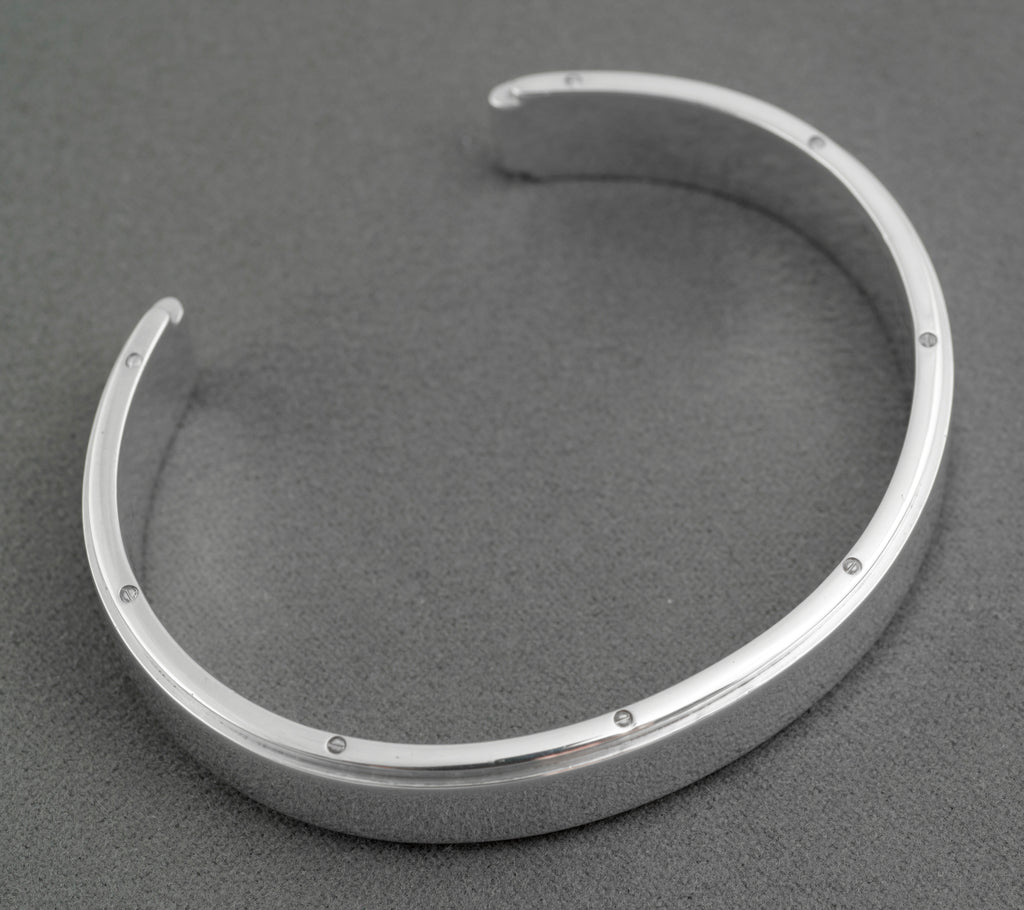 Tiffany and Co Metropolis sterling silver cuff bangle - 925 - side profile view on grey background showing width of flat top face raised central section and rounded inner edge profile