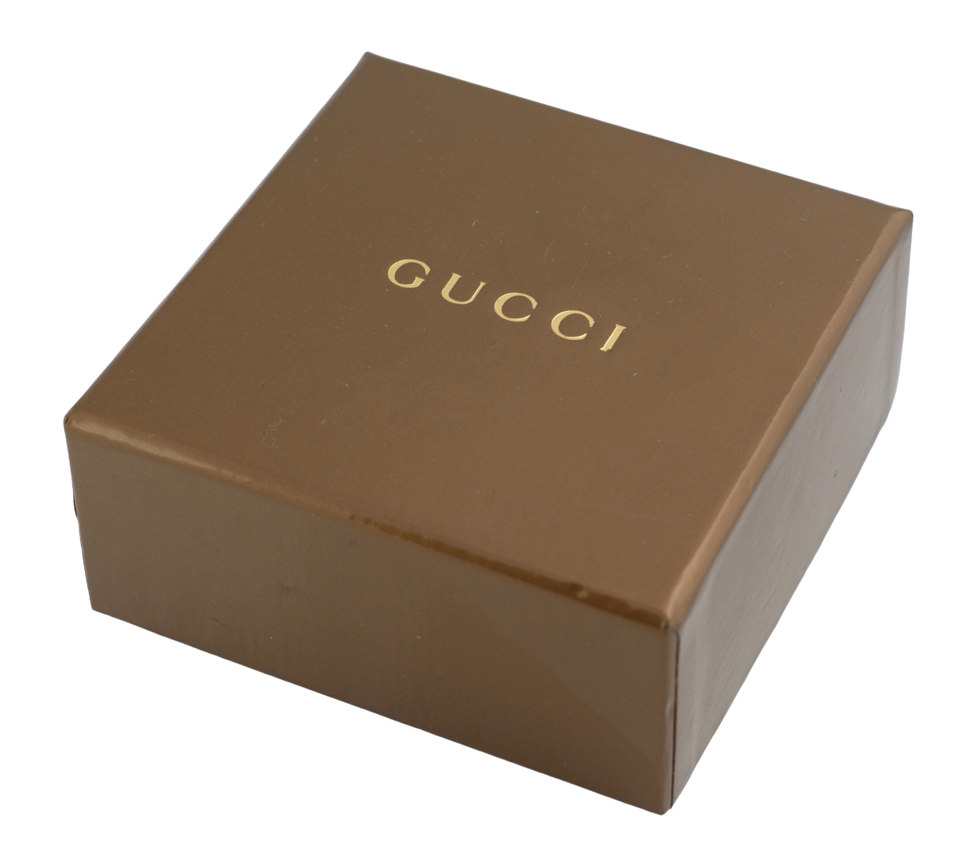 Vintage Gucci Chiodo sterling silver crossover bar ring resting on closed Gucci brown GG monogram embossed presentation box on white background