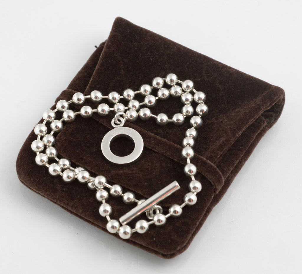 Vintage Gucci Boule sterling silver ball link necklace laid flat on white background showing full length of chain with toggle clasp and T bar pendant