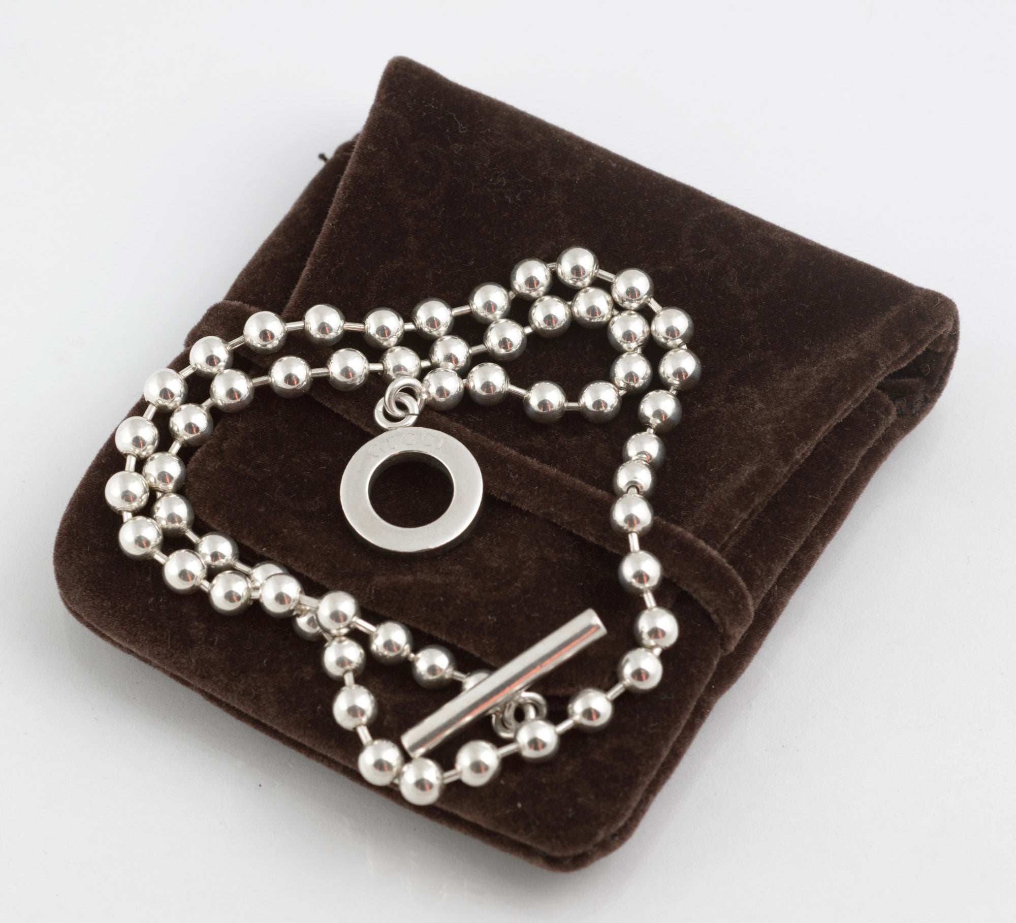 Vintage Gucci Boule sterling silver ball link necklace laid flat on white background showing full length of chain with toggle clasp and T bar pendant