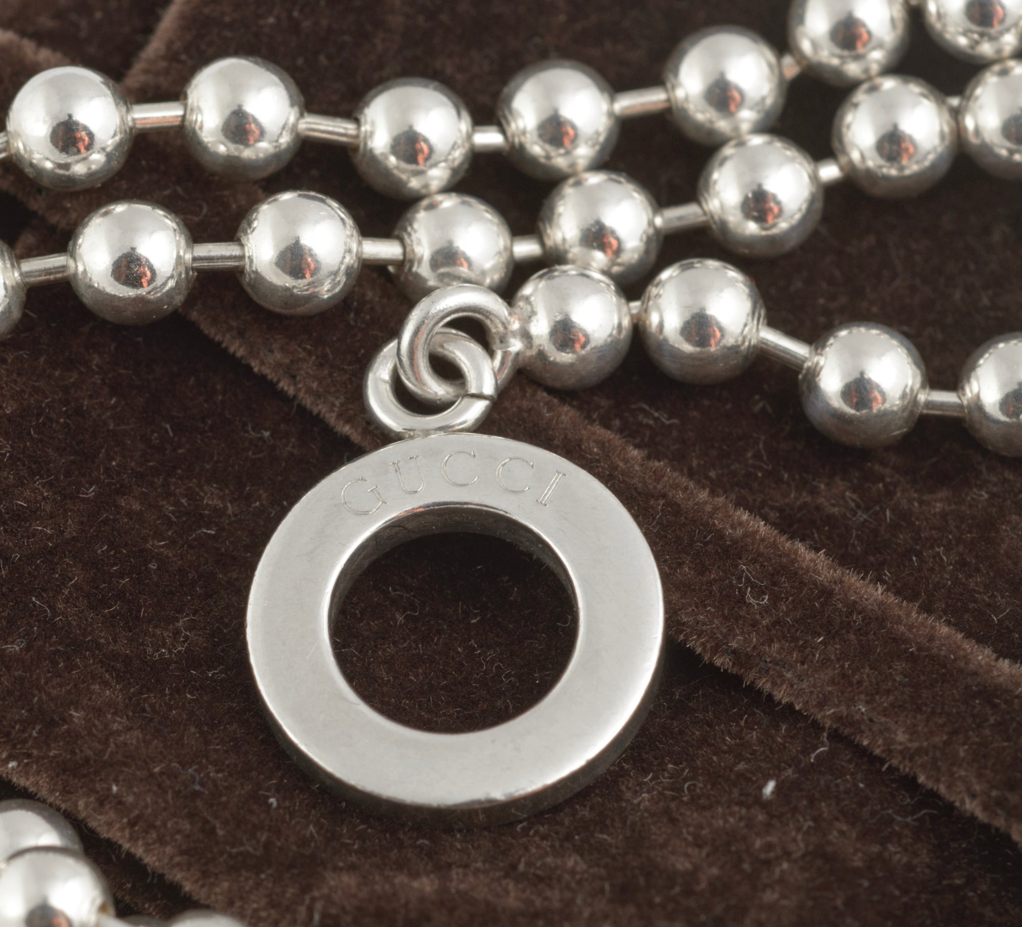 Vintage Gucci Boule sterling silver ball link necklace laid flat on white background showing reverse side of toggle ring with Italian silver hallmarks and Gucci Made in Italy branding
