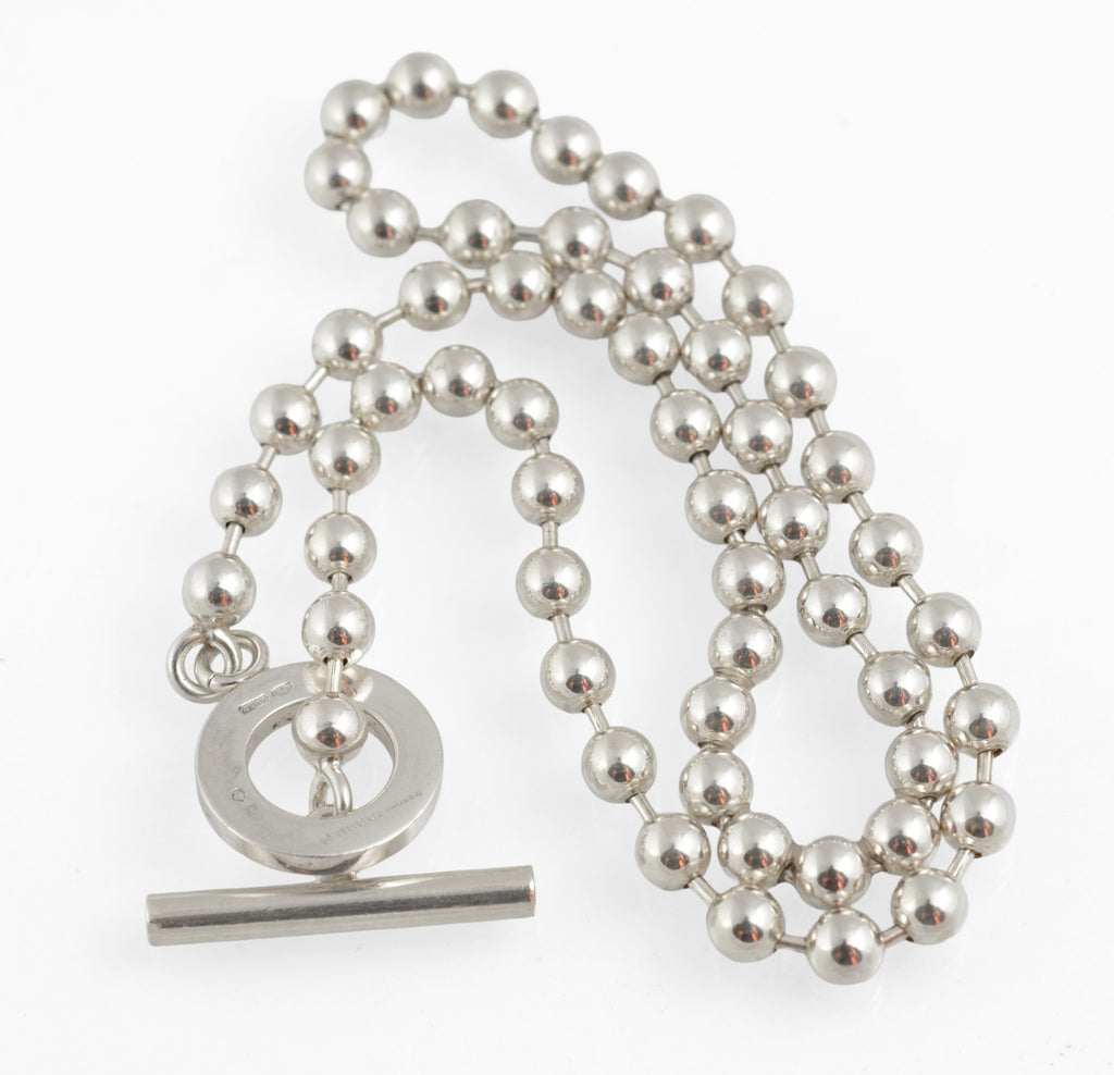 Dark brown Gucci presentation box open showing interior with Gucci Boule sterling silver ball link necklace inside