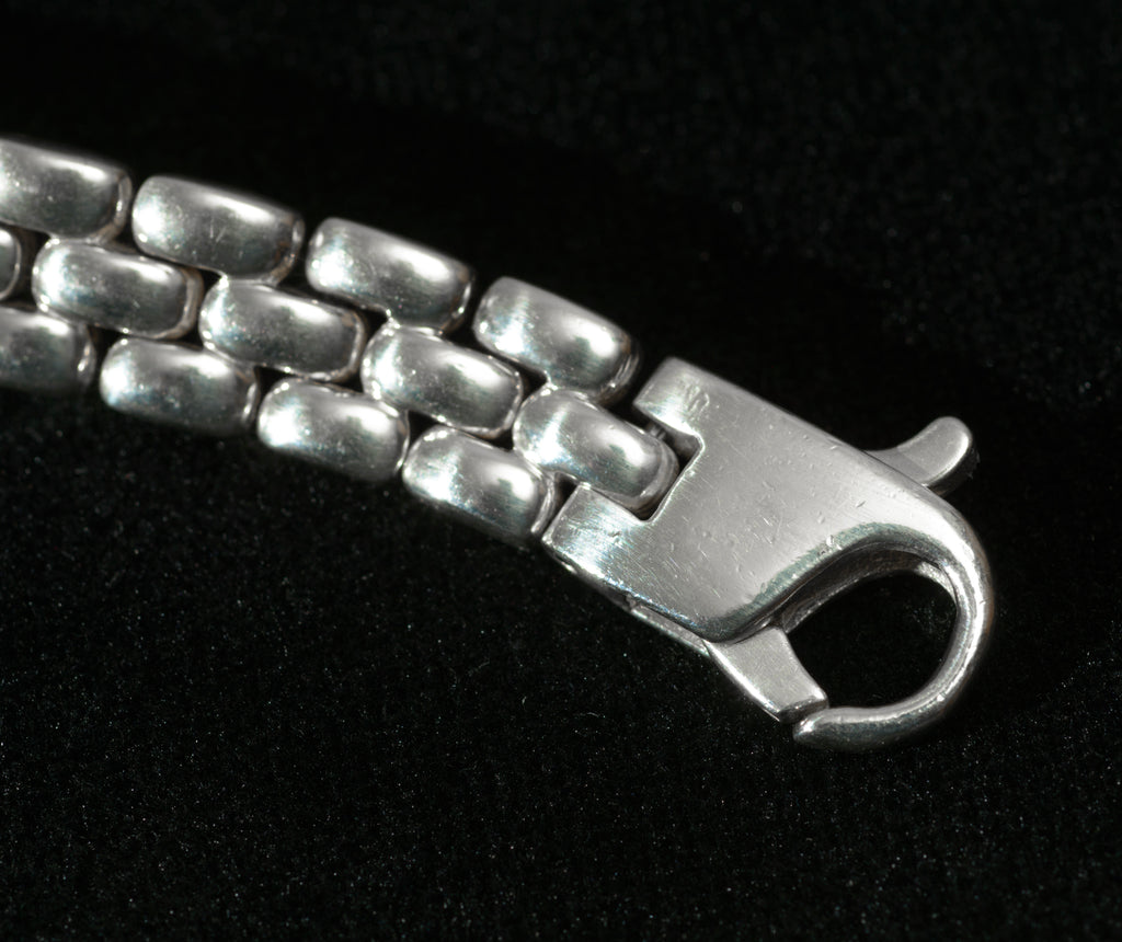 Heavy sterling silver three row brick link necklace laid flat on black background showing close view of brick link pattern and 9.5mm width profile