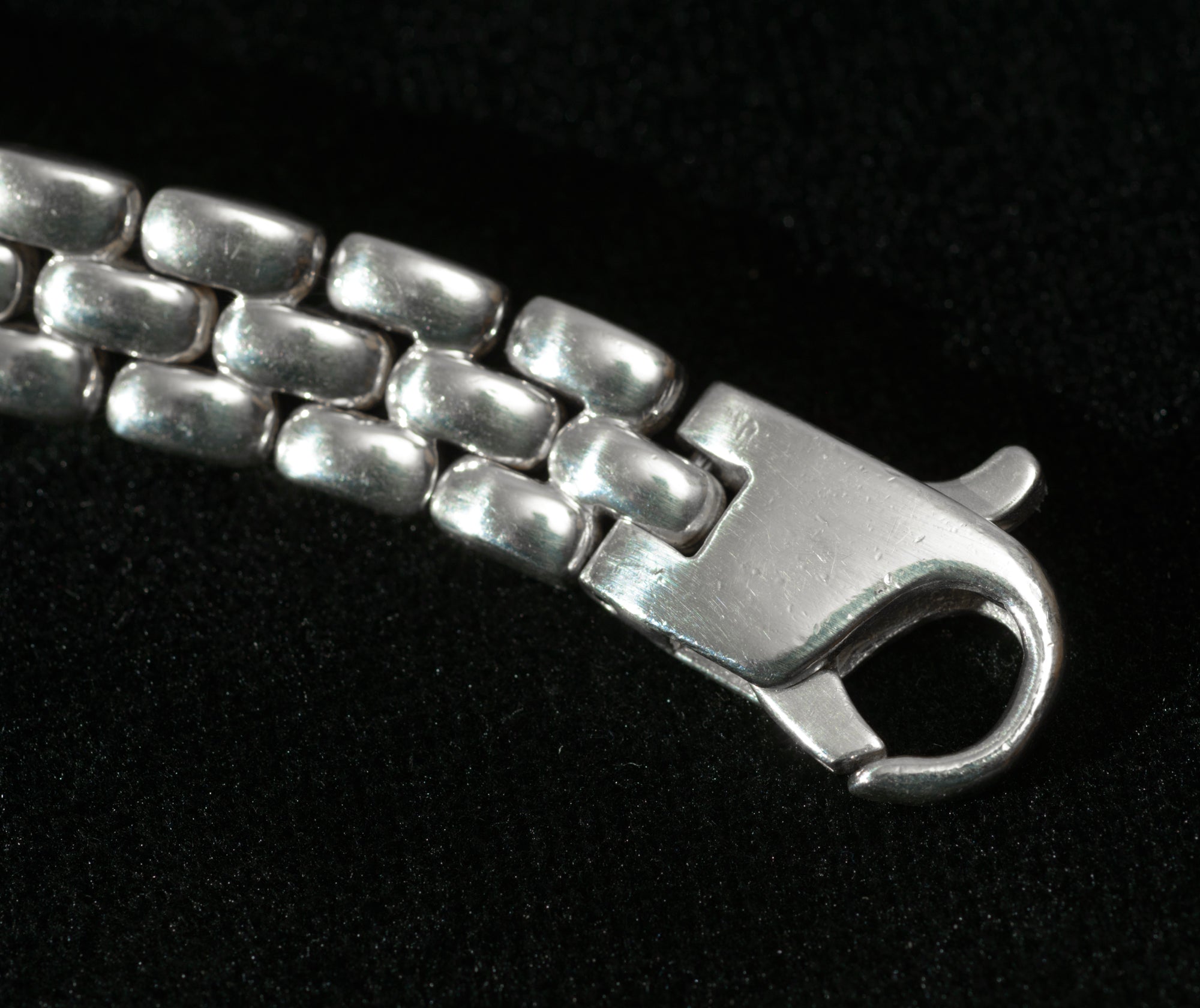 Heavy sterling silver three row brick link necklace laid flat on black background showing close view of brick link pattern and 9.5mm width profile
