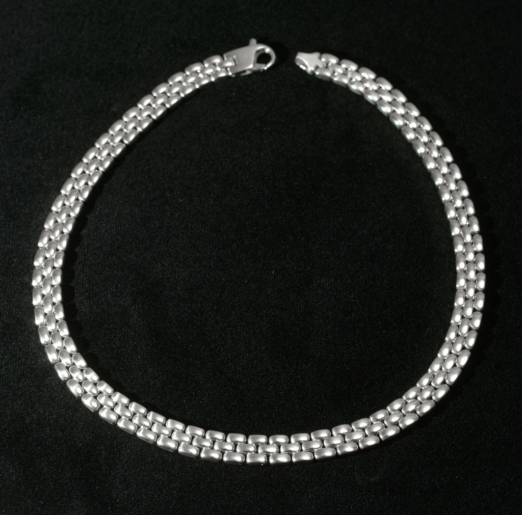 Heavy sterling silver three row brick link necklace laid flat on black background showing full length of necklace with flat lobster clasp