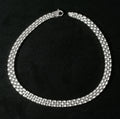 Heavy sterling silver three row brick link necklace laid flat on black background showing full length of necklace with flat lobster clasp