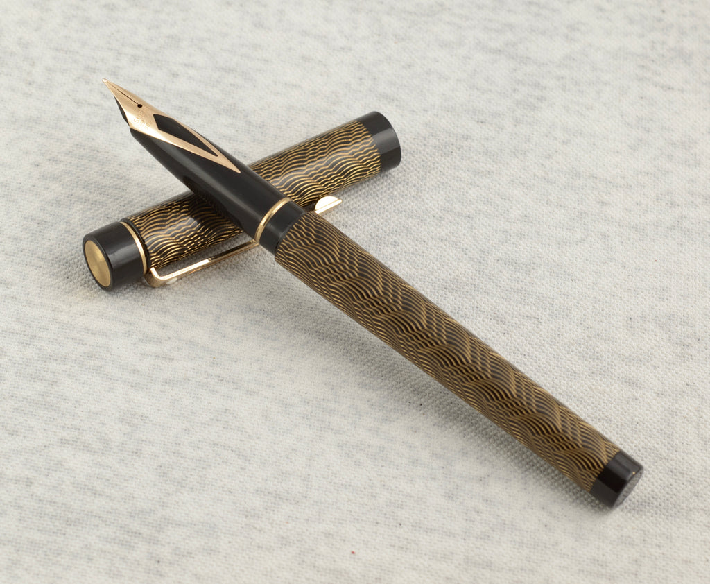Sheaffer removable converter with red fill aperture alongside Sheaffer Targa 676 Classic fountain pen Gold Feather finish on linen background