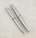 Lady Sheaffer 620 Florentine set disassembled on linen background showing fountain pen cap barrel with converter pencil cap and pencil barrel as four separate components