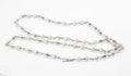 Vintage sterling silver long necklace with sculptural double cone reel links joined by fine chain laid flat on white background showing full 93cm length and T-bar toggle clasp