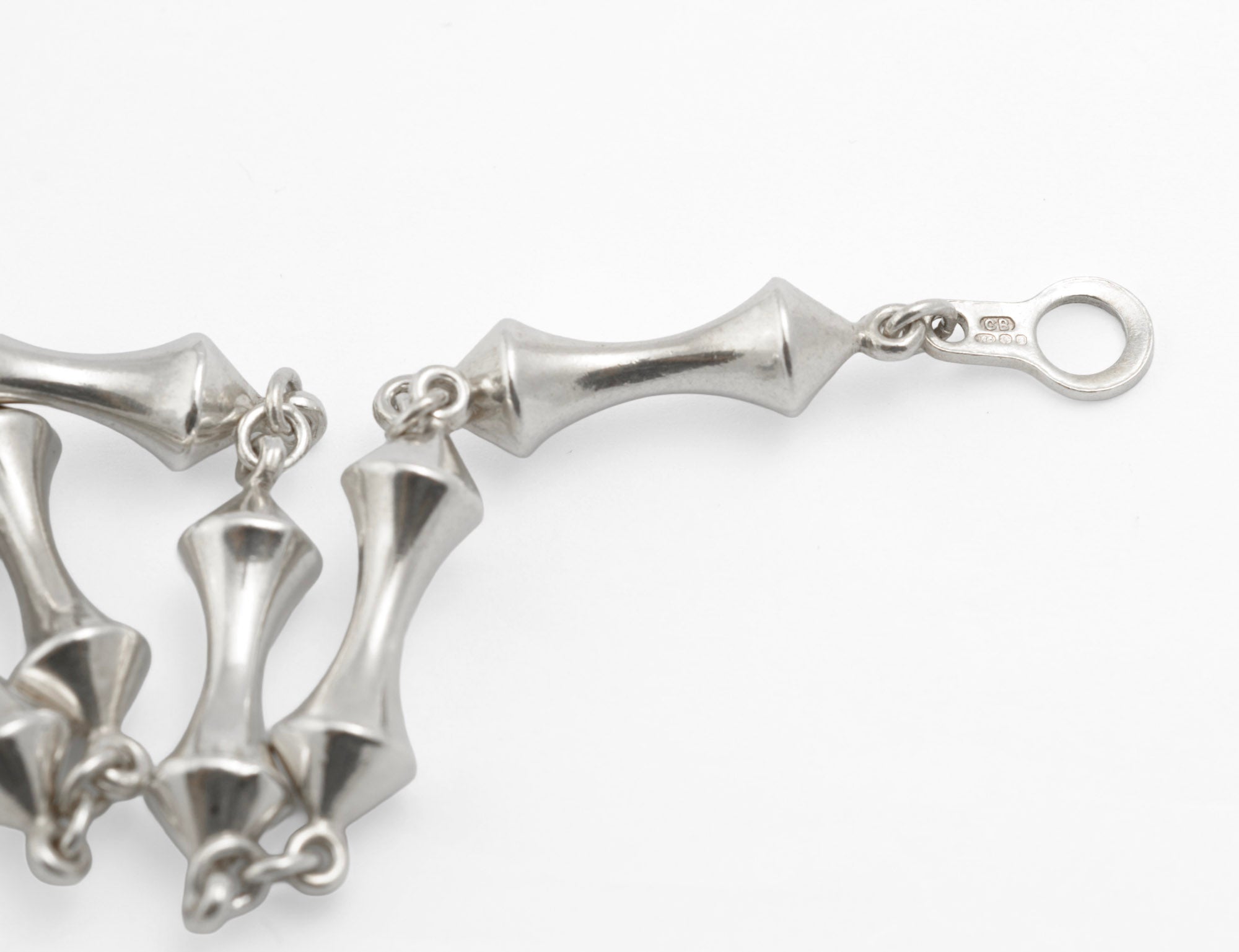 Close up of vintage sterling silver long necklace T-bar toggle clasp end showing hallmark stamp and sponsor's mark CB on white background