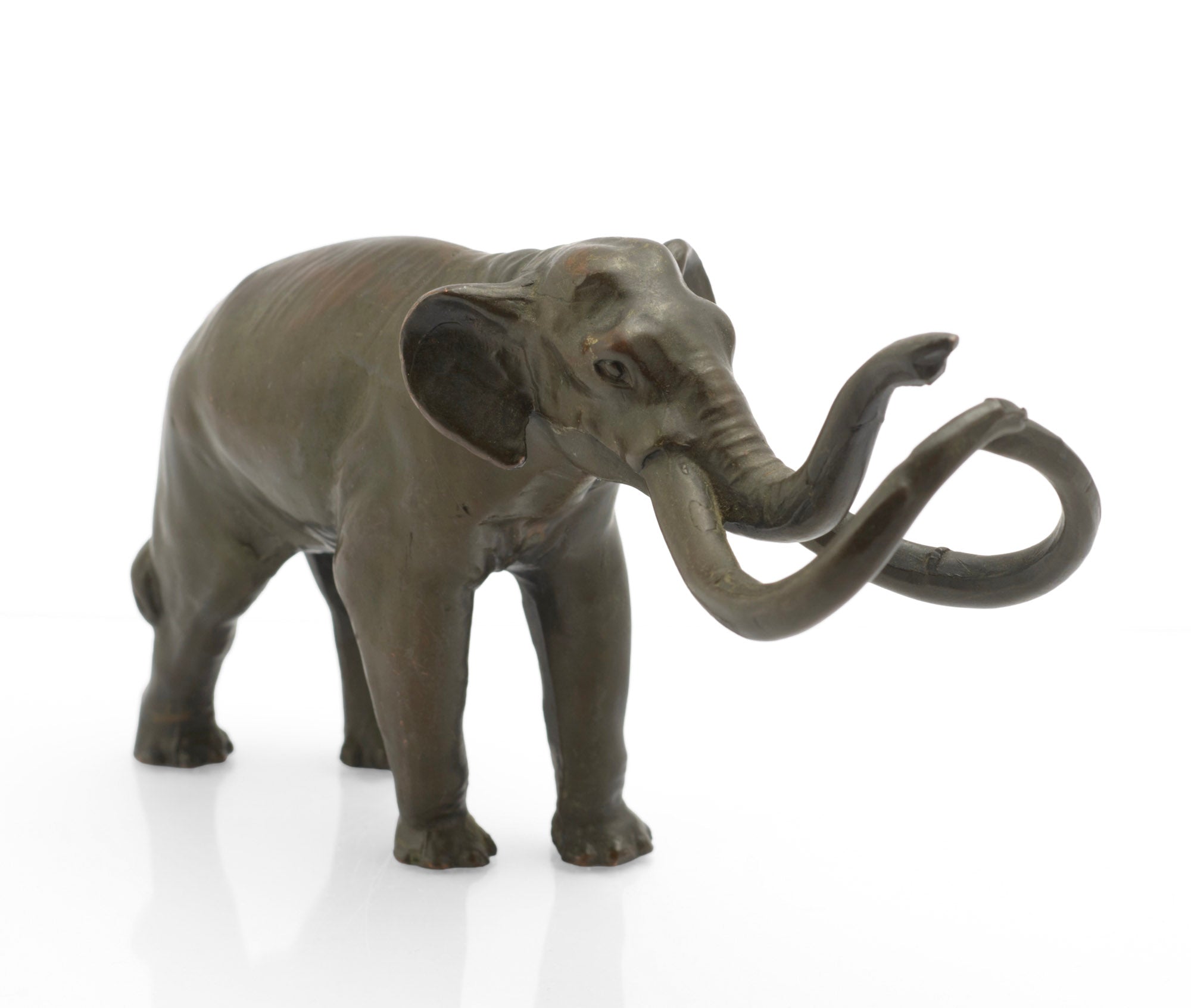 A vintage bronze Imperial Mammoth figure by William Wm. Otto, from the La Brea Tar Pits prehistoric animal series produced around the late 1950s and 1960s. Cast with the maker's mark to the inside of one leg and finished with a dark brown patina showing olive green tones.